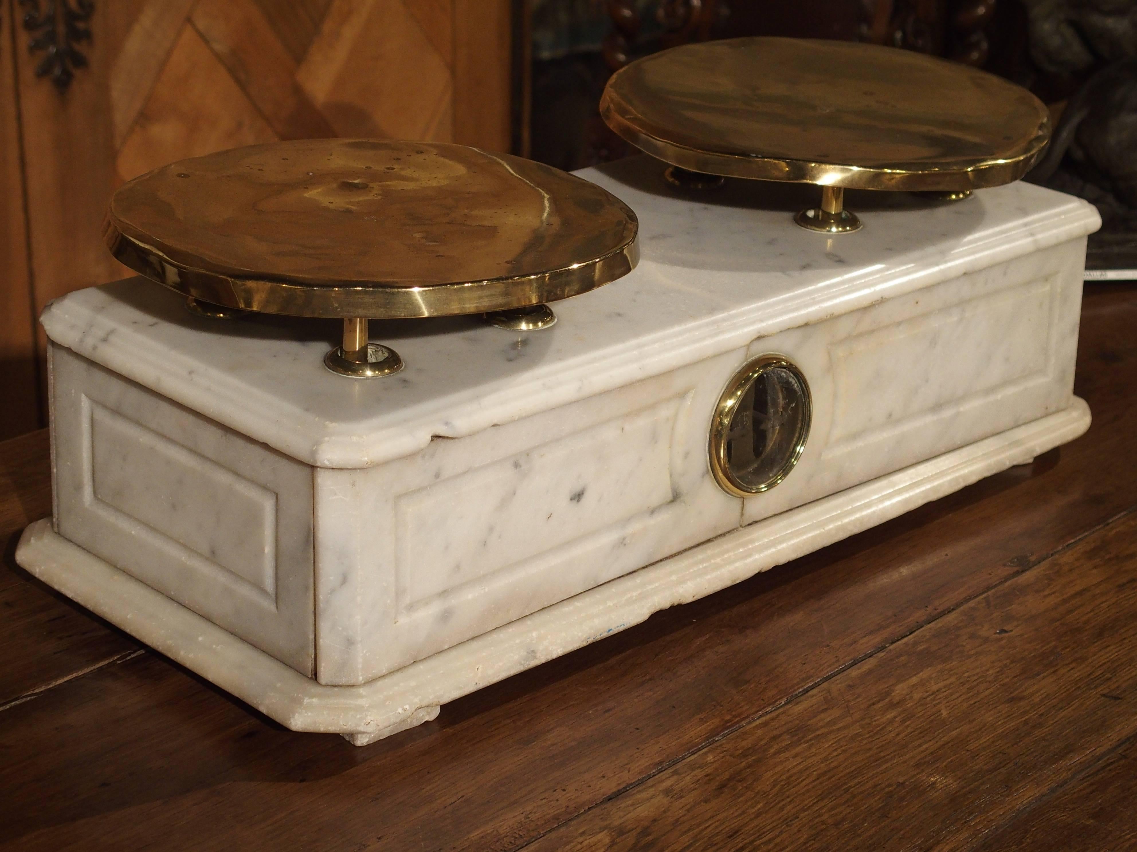 Comes with complete set of weights

From Paris, this Boulangerie (bakery) scale makes a wonderful statement with its veined white marble and gleaming brass platters. Weights would be placed upon one side, while the other side held the goods to be