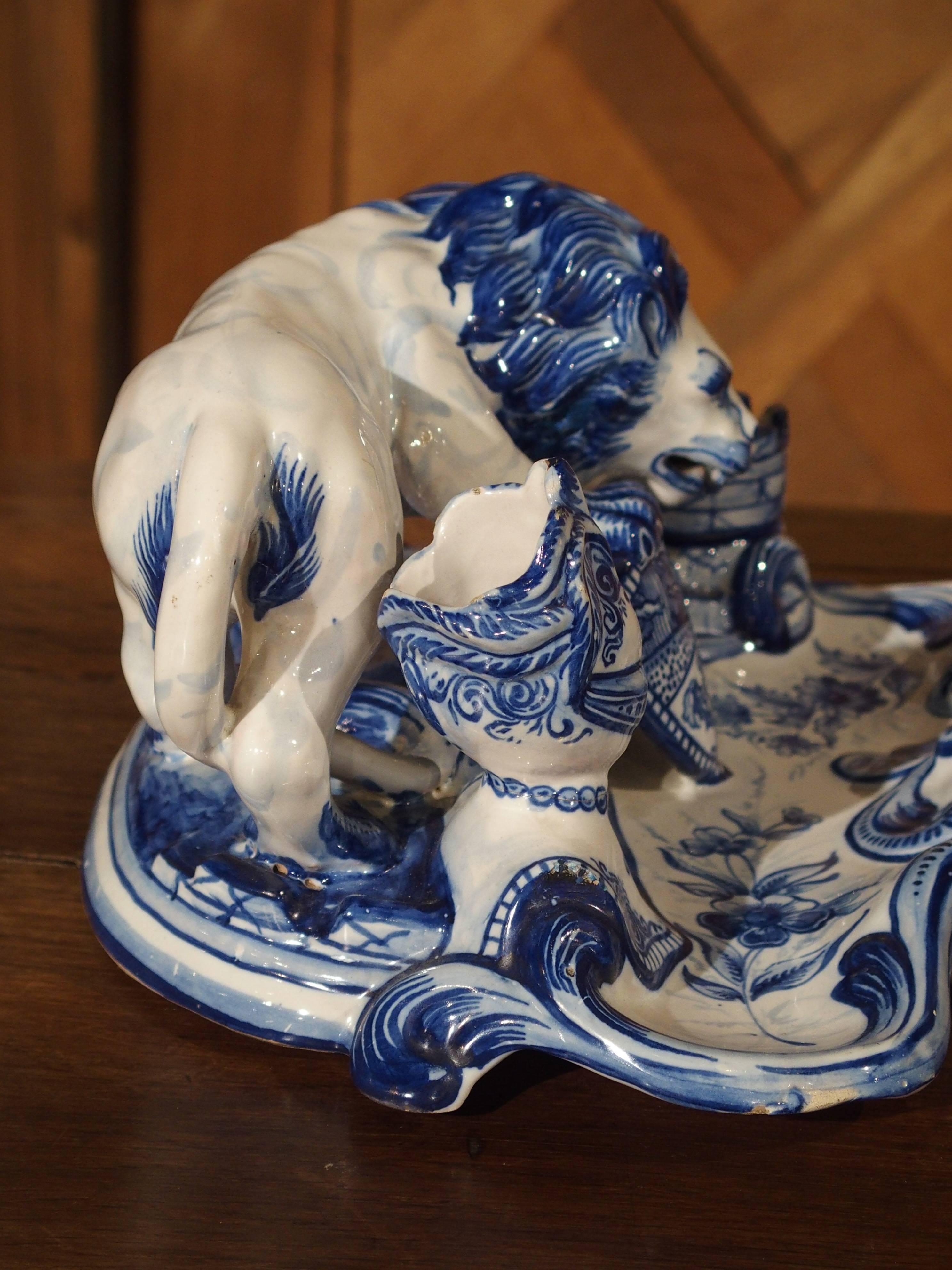This cobalt blue on white ground, French faience heraldic inkwell dates to the early 1900s. It is after Emile Galle and the designer, Gengoult Prouve who had designed similar candle holders and inkwells in France during the late 1800s. The lion’s