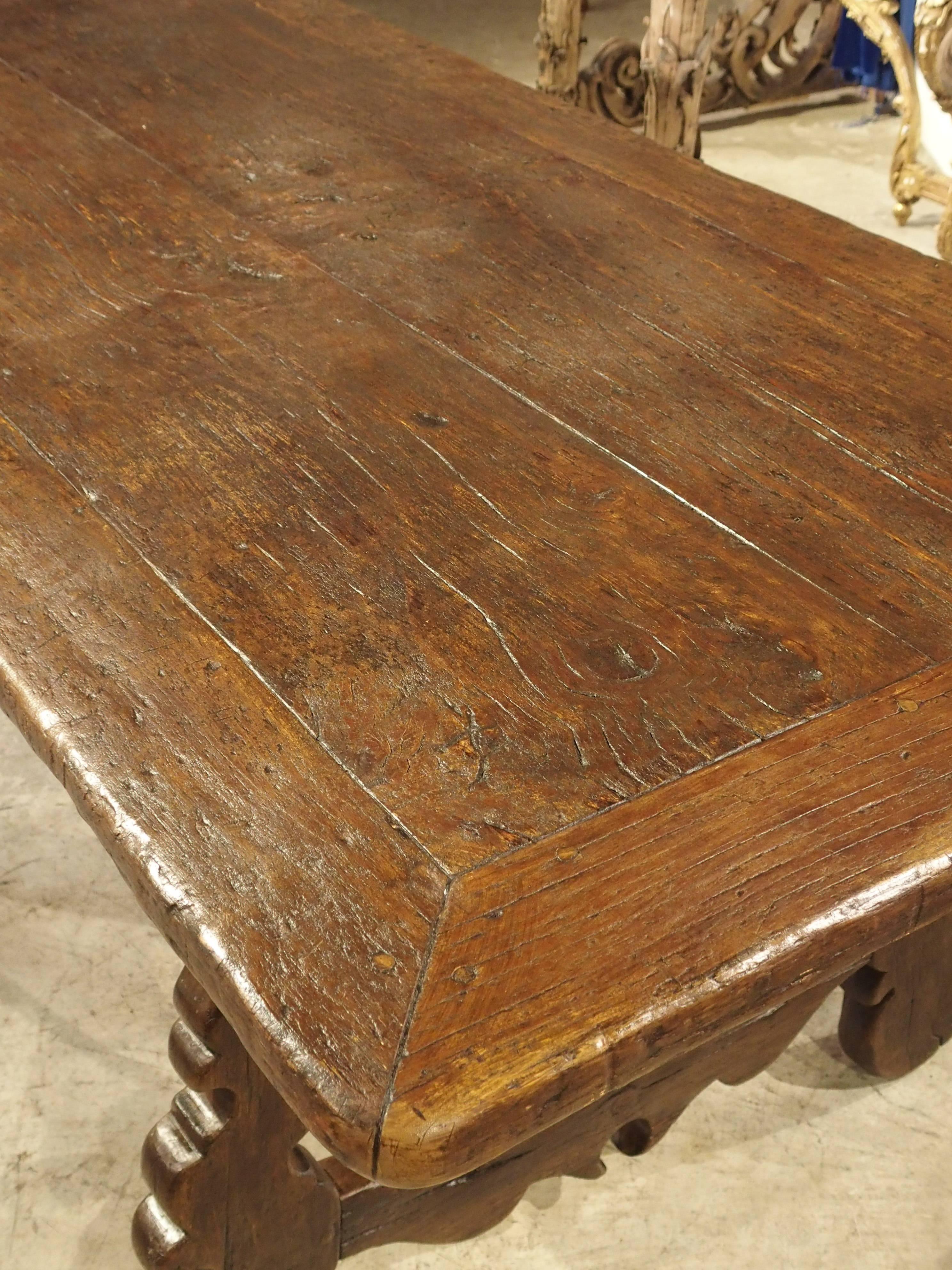 This long antique table from Spain was made in the 1700s. The raised grain of the elmwood on the tabletop is absolutely wonderful and gives it a very distinct look. It is a very functional table because of this. Placing pieces on the table will not