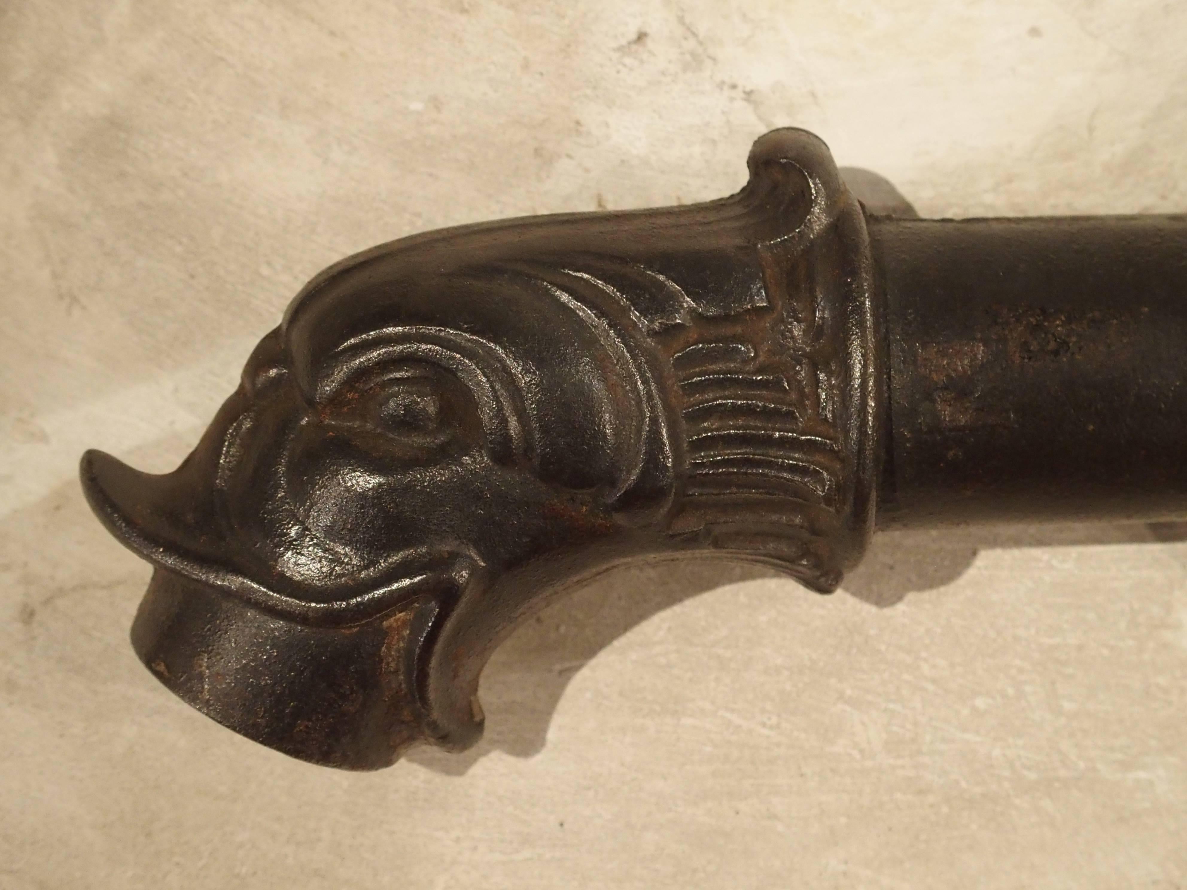 This antique French cast iron fountain spout has a stylized dolphin motif at the spout. When France was ruled by Kings, the heir to the throne was known as the Dauphin (Dolphin in French), therefore we see the dolphin motif used throughout many