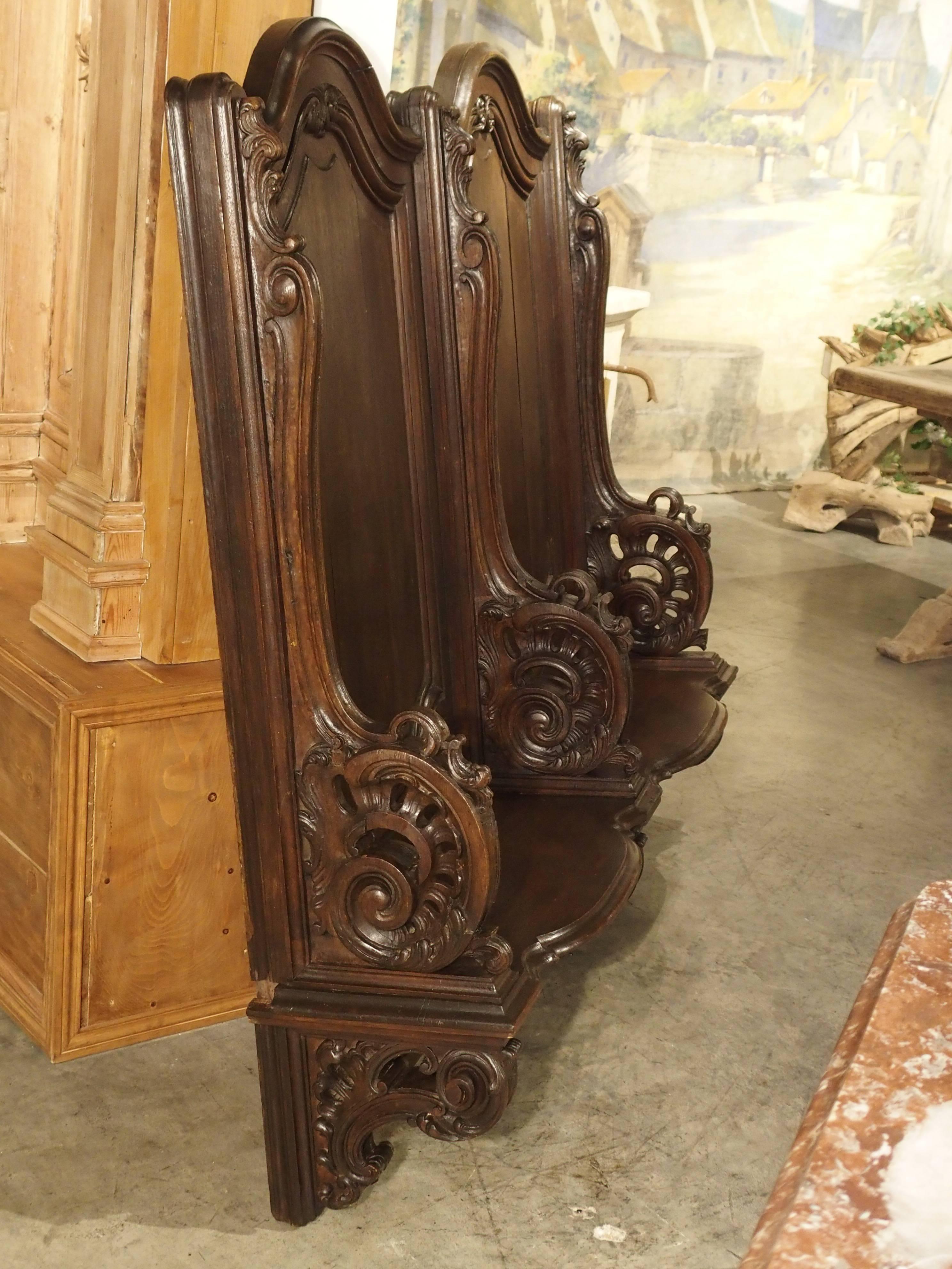 This European oak church stall came from a private chapel of a chateau in Liege, Belgium. This double stall would have been attached to the wall.

There are two seats with central domed tops separated by heavily carved arms. The arms are shaped with