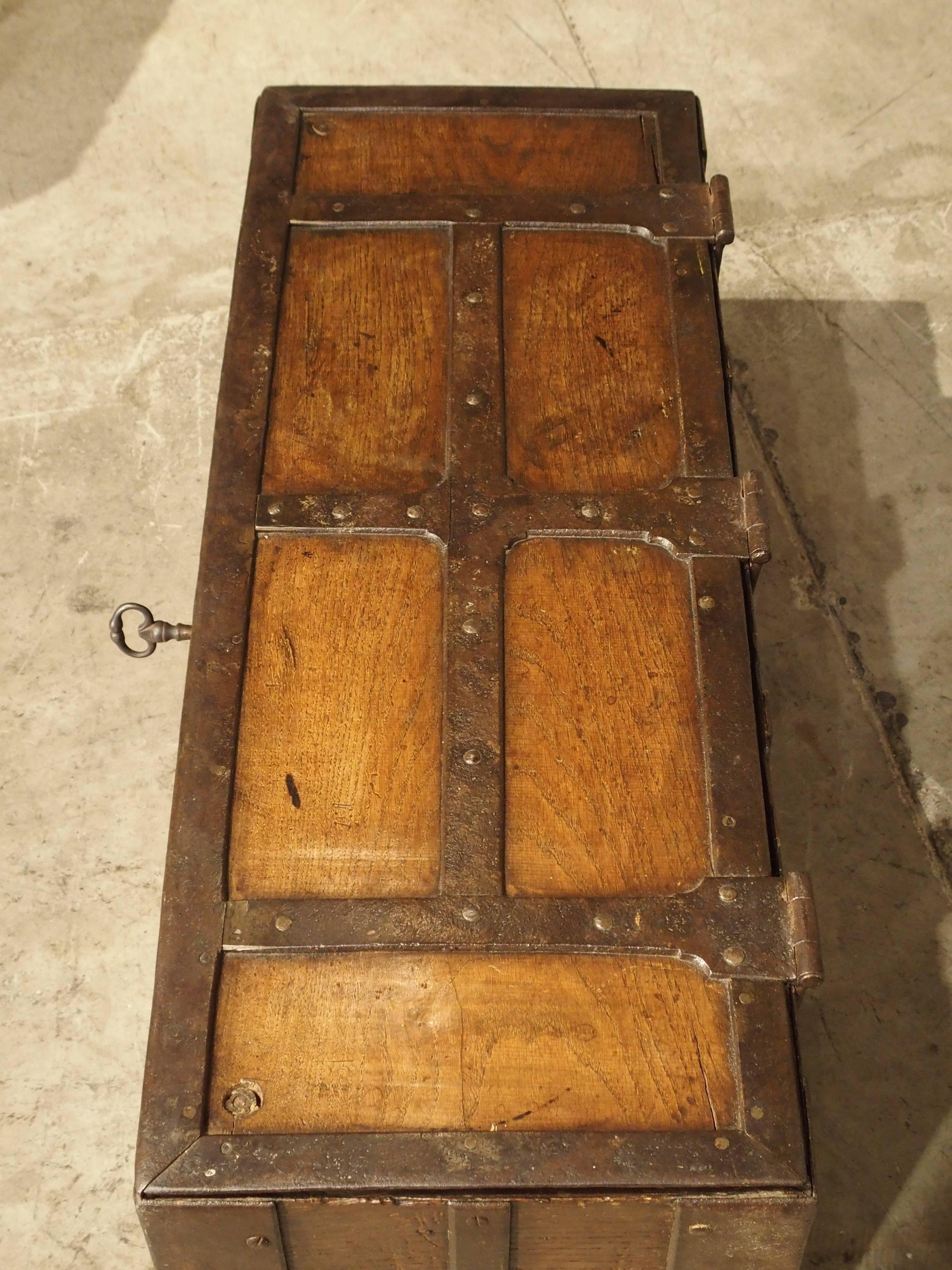 From the 1600s, this French money trunk is heavily clad with thick, iron strapping that goes completely around the trunk. Though this trunk’s ironwork was designed for the security of the money, it did not lack artistic design as noted on the front