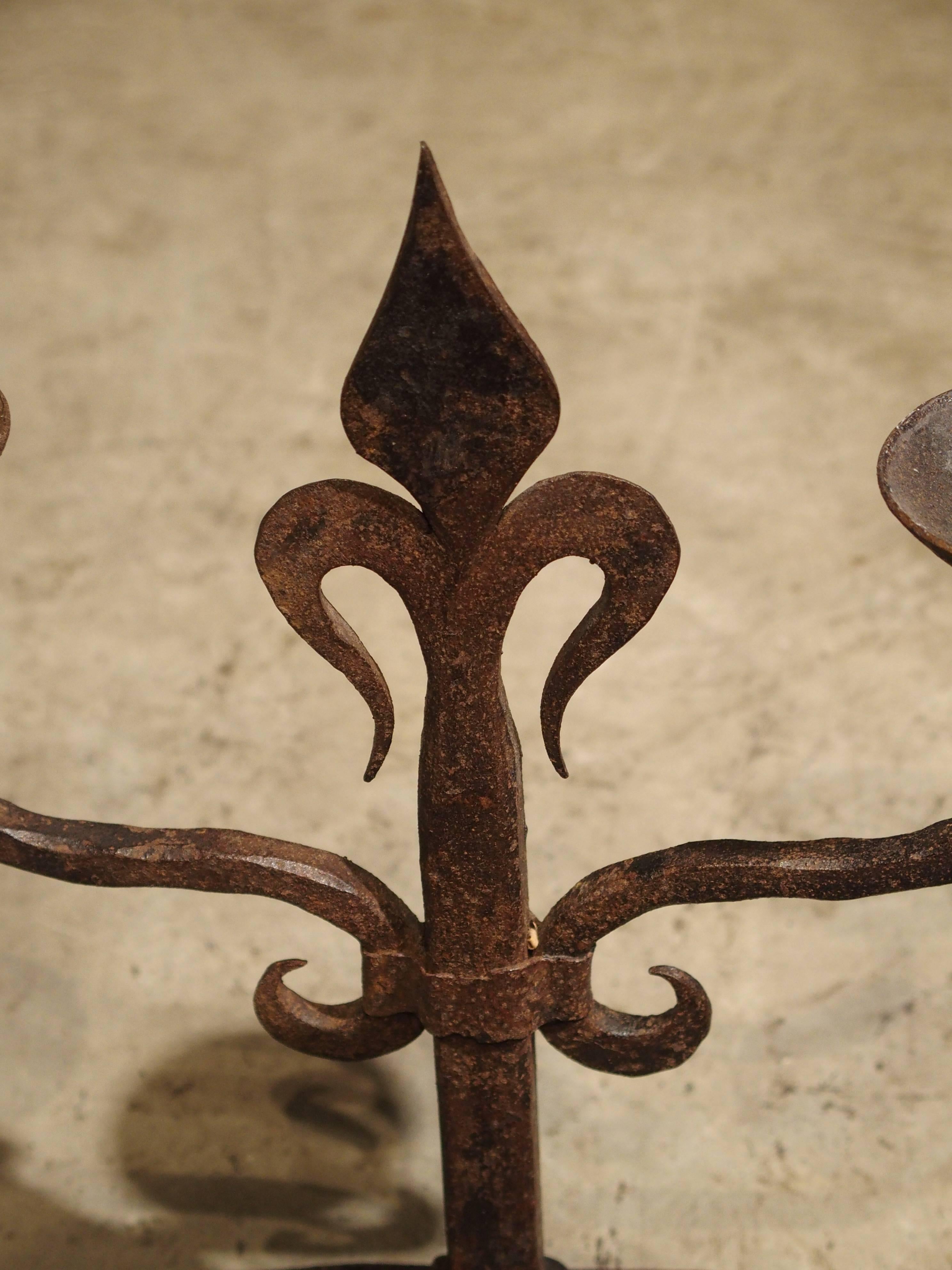 Pair of French Fleur De Lys Forged Iron Candelabras In Good Condition In Dallas, TX