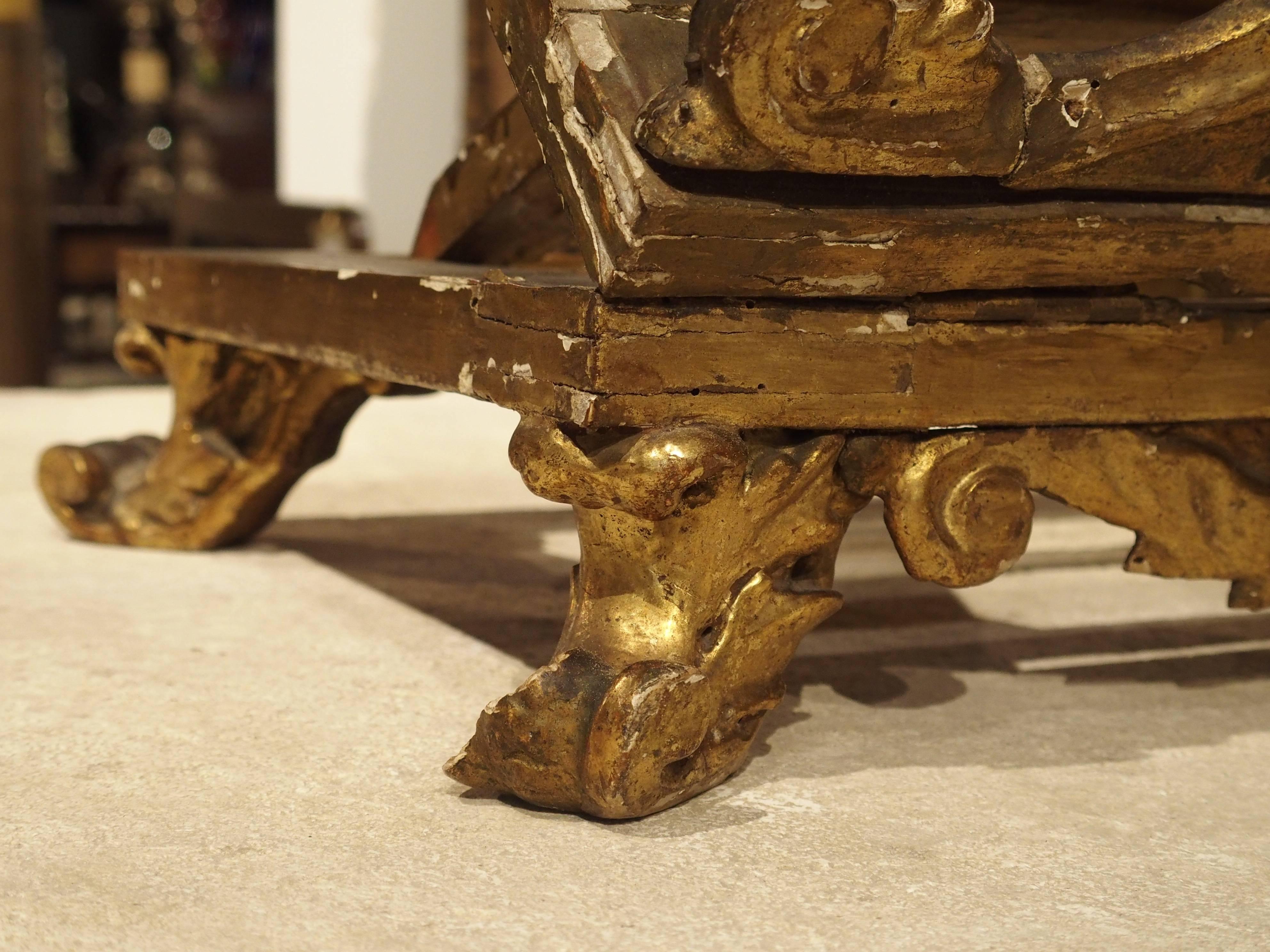 This antique parcel-gilt wooden table lectern is perfect for any area of the home. It is gesso and gold leaf over carved wood and dates to the early 1800s. It is adjustable in height so reading or displaying books, and can also fold flat (see