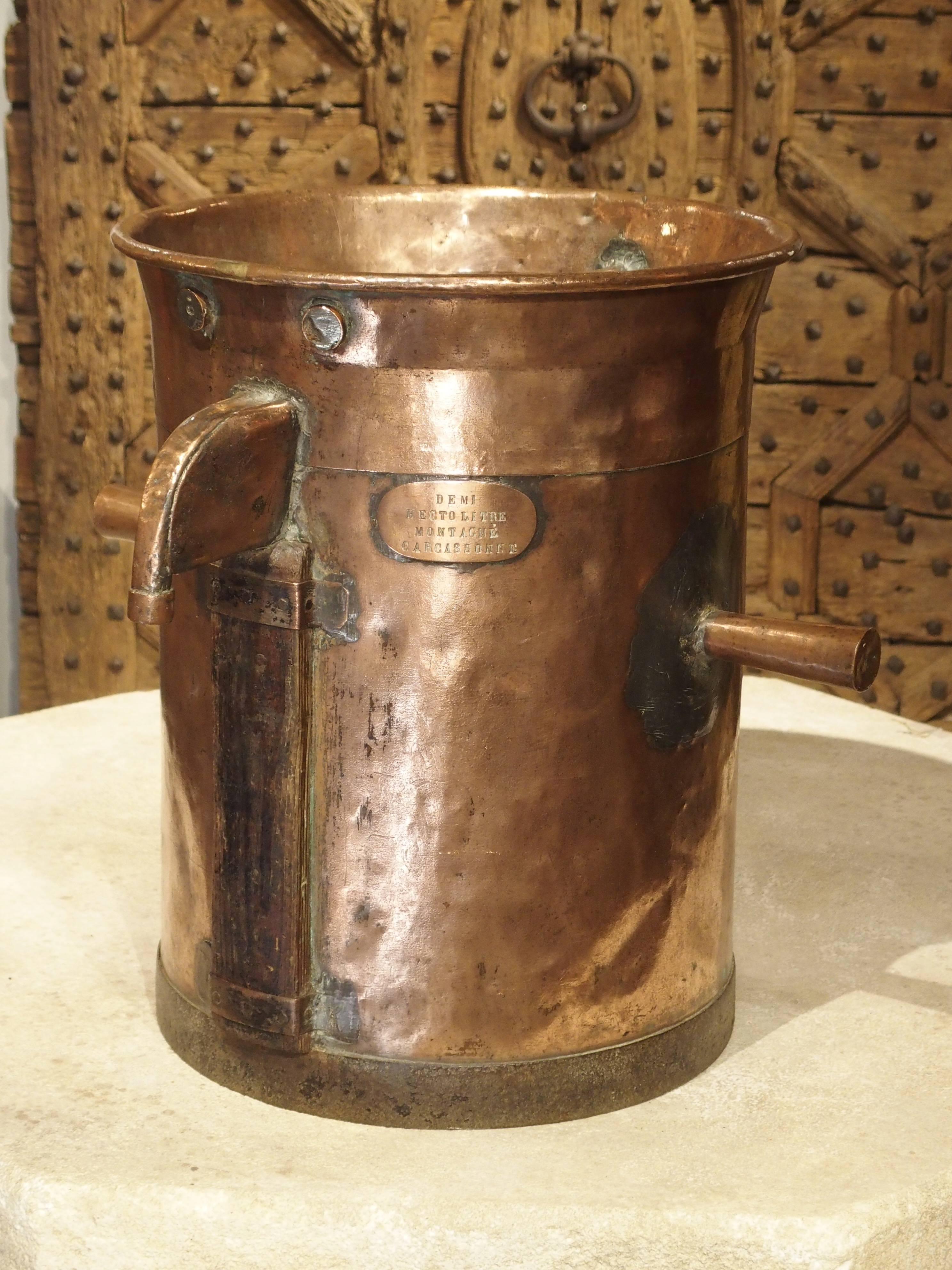 This beautiful copper object was a measuring and dispensing device used by a French wine producer circa 1850. The capacity is 50 liters and it is stamped with the name Montagne Carcassonne. This Community of vineyards, with a rich wine making