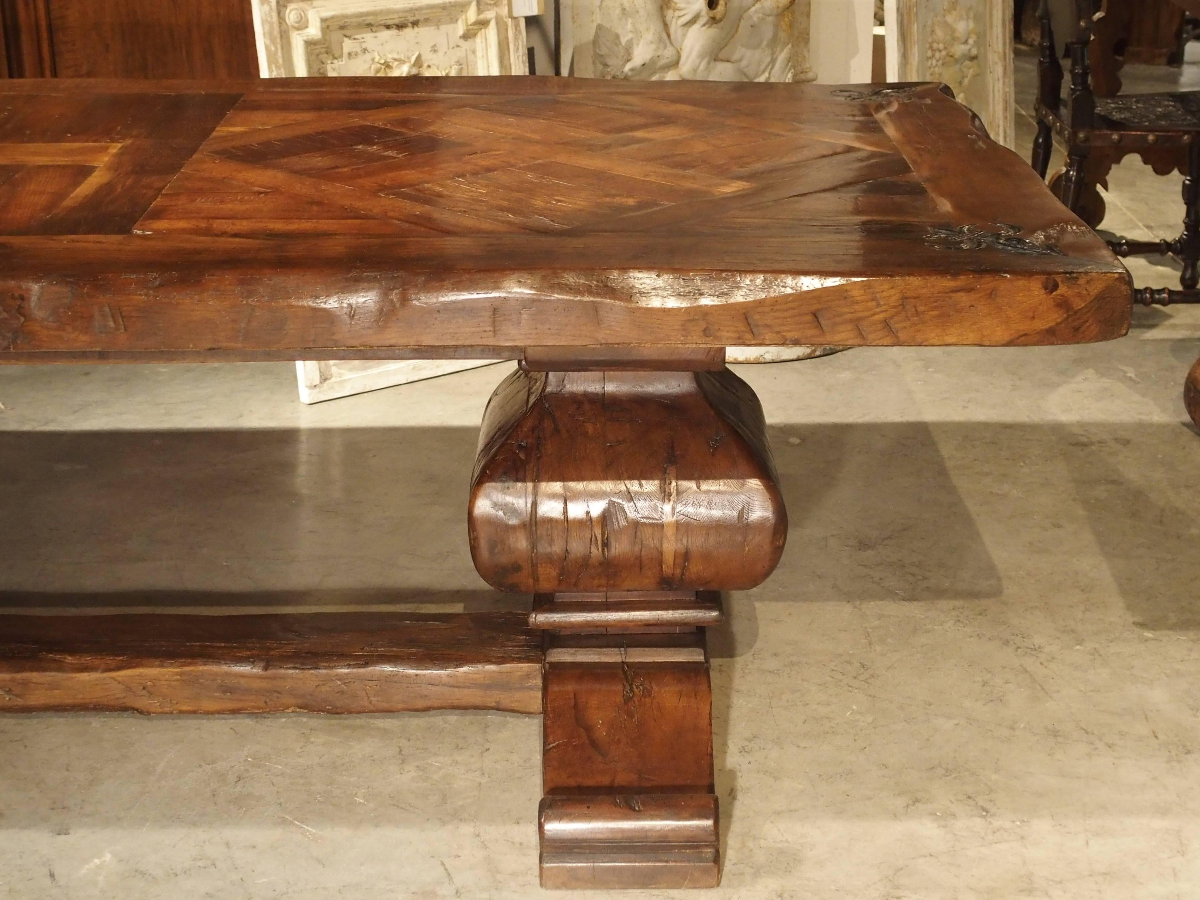Français Grande table de salle à manger en chêne français avec plateau en parquet et coins en forme de fleur de lys