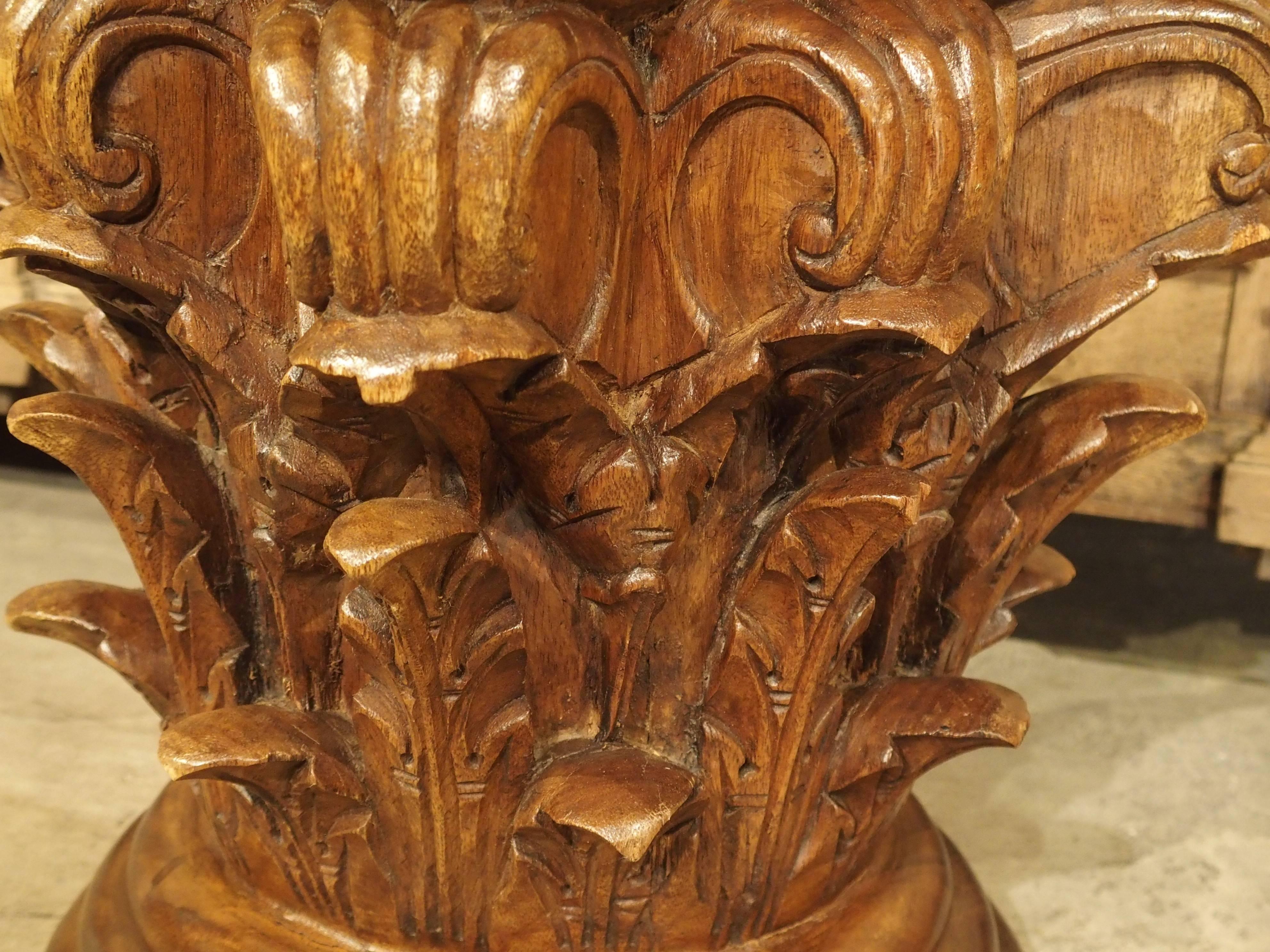 This beautifully hand-carved walnut wood capital has acanthus leaves and stylized c-scrolls for its ornamentation. The upper four-sided top or abacus has flowers centered on all sides. Note the rings of the tree showing on the top’s surface. All