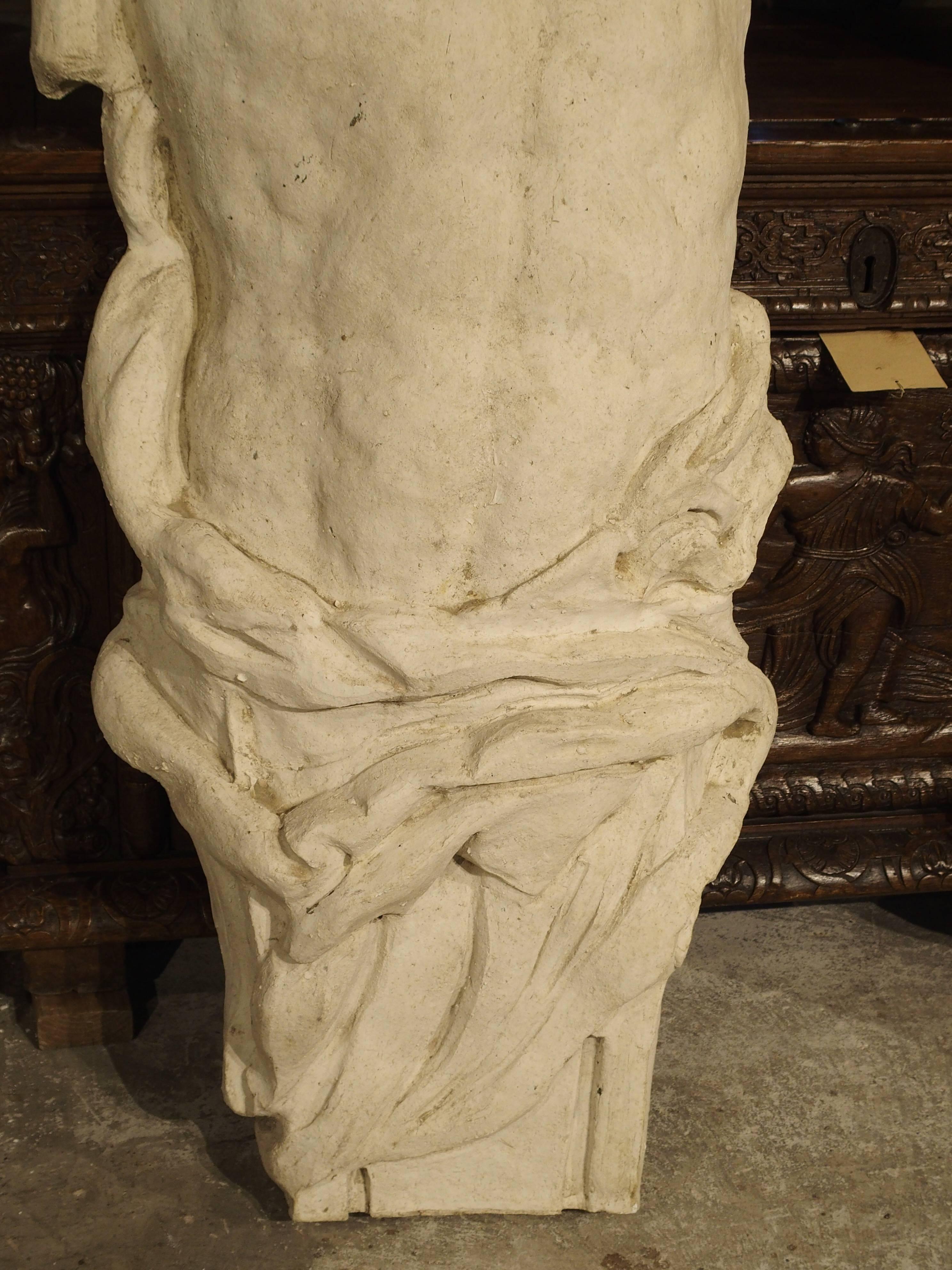 This pair of large male Atlases’ from France has been made from plaster and fiberglass. They are the male version of a caryatid, used as architectural column supports in the shape of a human figure. They are hollow in the back, with arms folded over