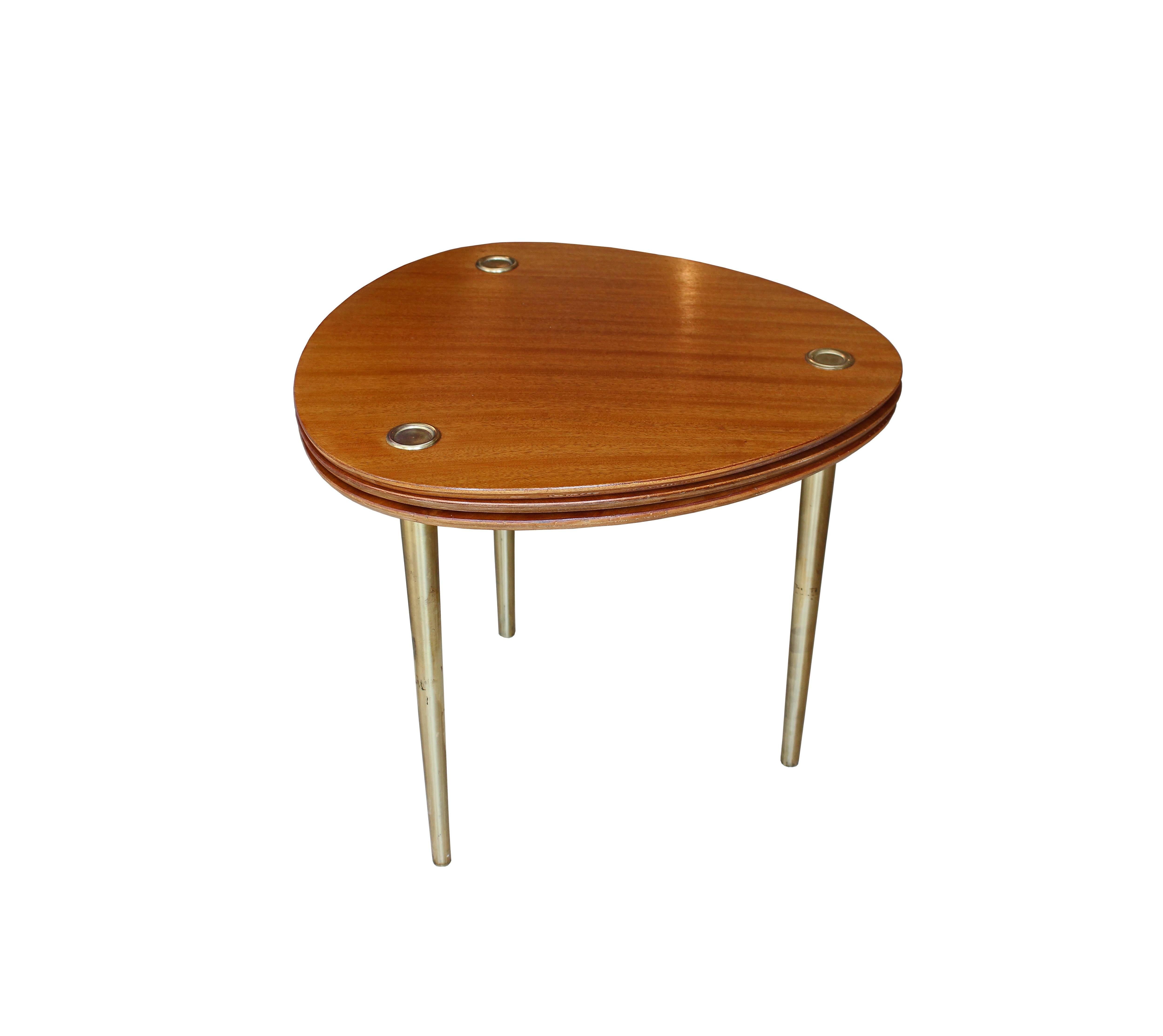 Set of three table in mahogany with tapering brass legs. These tables fit into each other for use as a single table or can be used as three separate units.