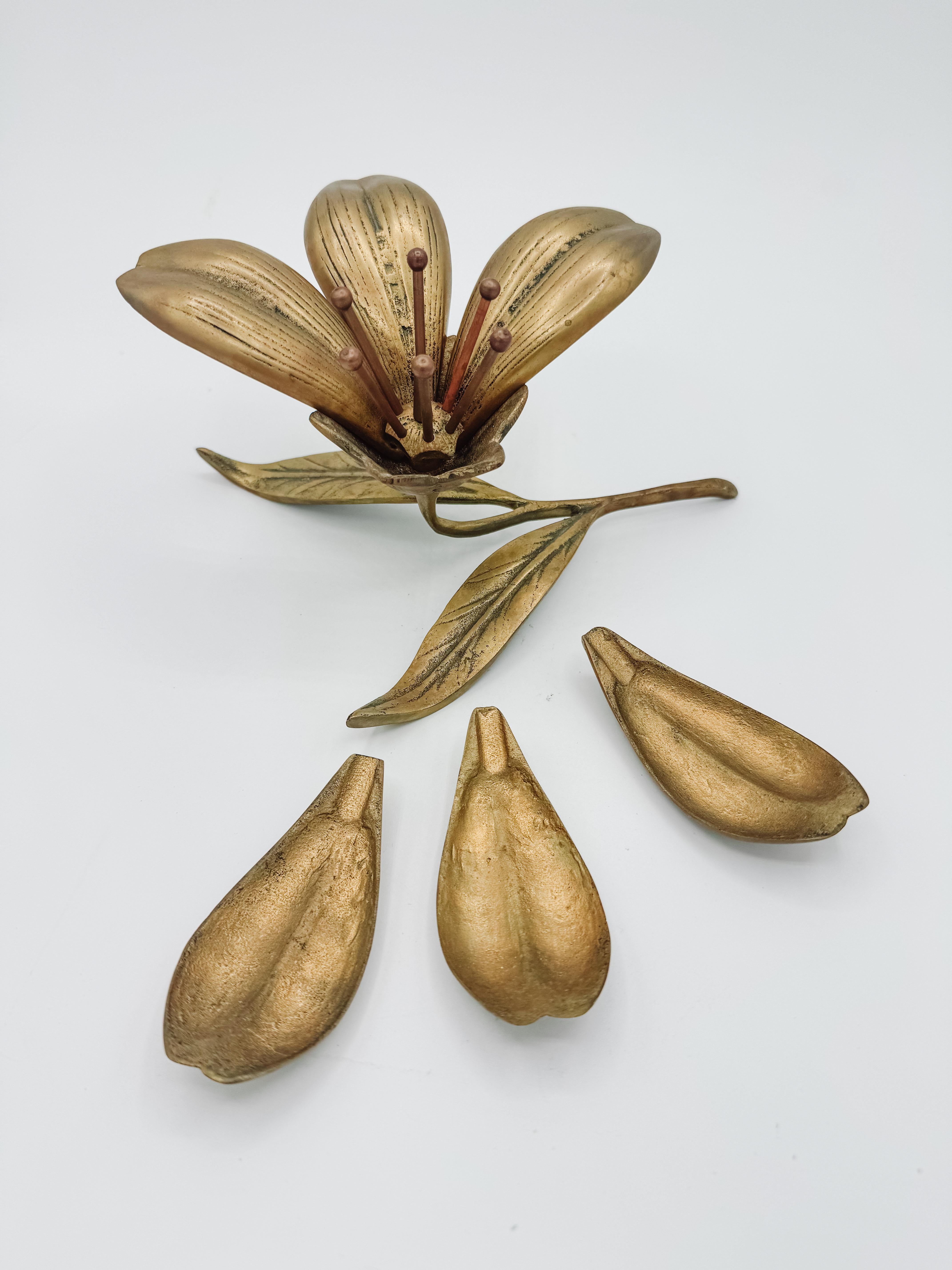 This stunning Vintage Brass Art Deco Ashtray is designed in a unique floral shape, featuring six removable brass petals that flip over to function as individual ashtrays, making it both practical and visually captivating. Inspired by the elegance of