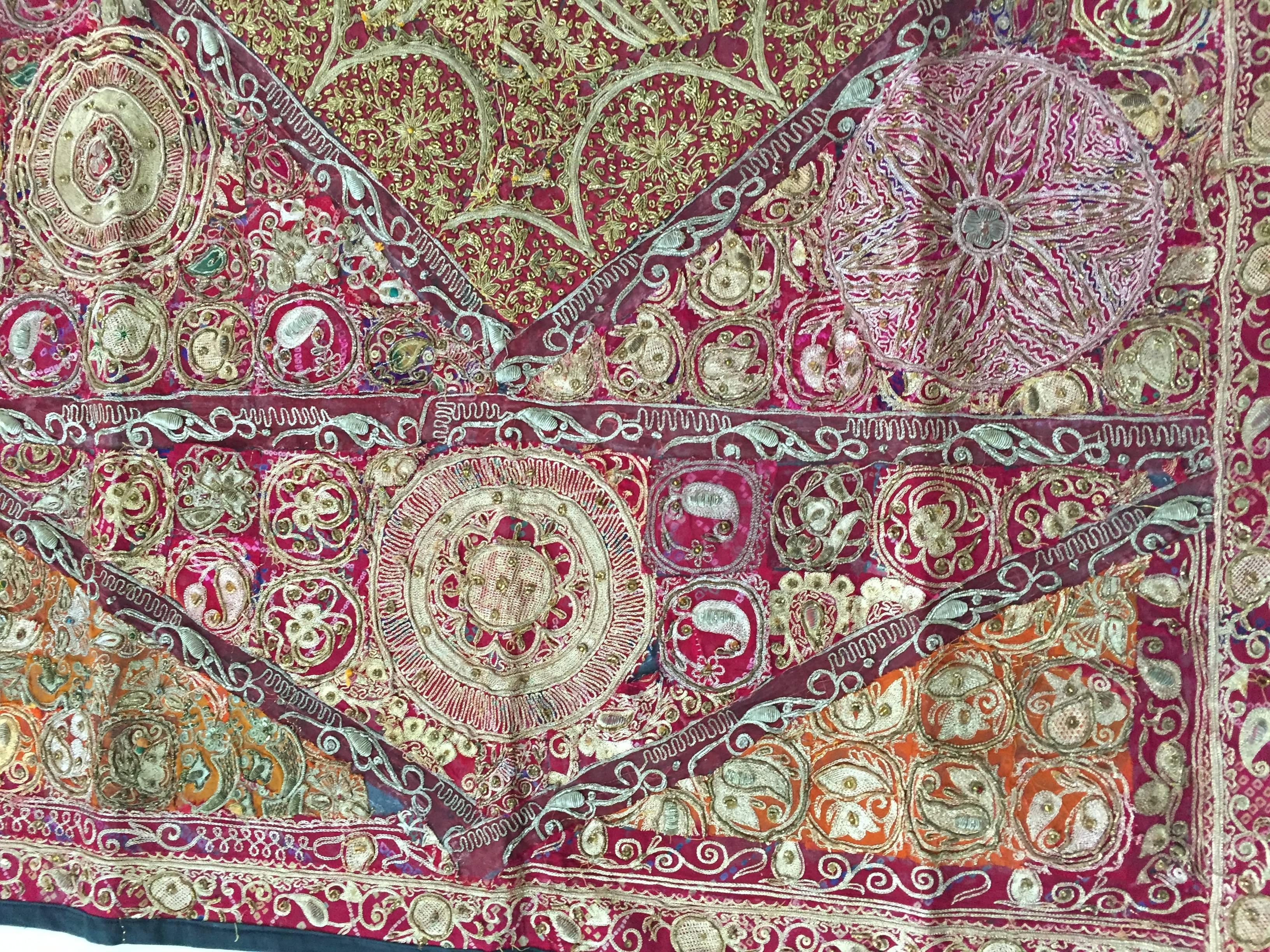 Hand embroidered and quilted textile from North India.
Mughal silk and metal threaded tapestry.
Backed with black linen.
Fanciful Asian folk designs this distinctive quilt work is a true sense of artistic freedom.
The majority of the border is