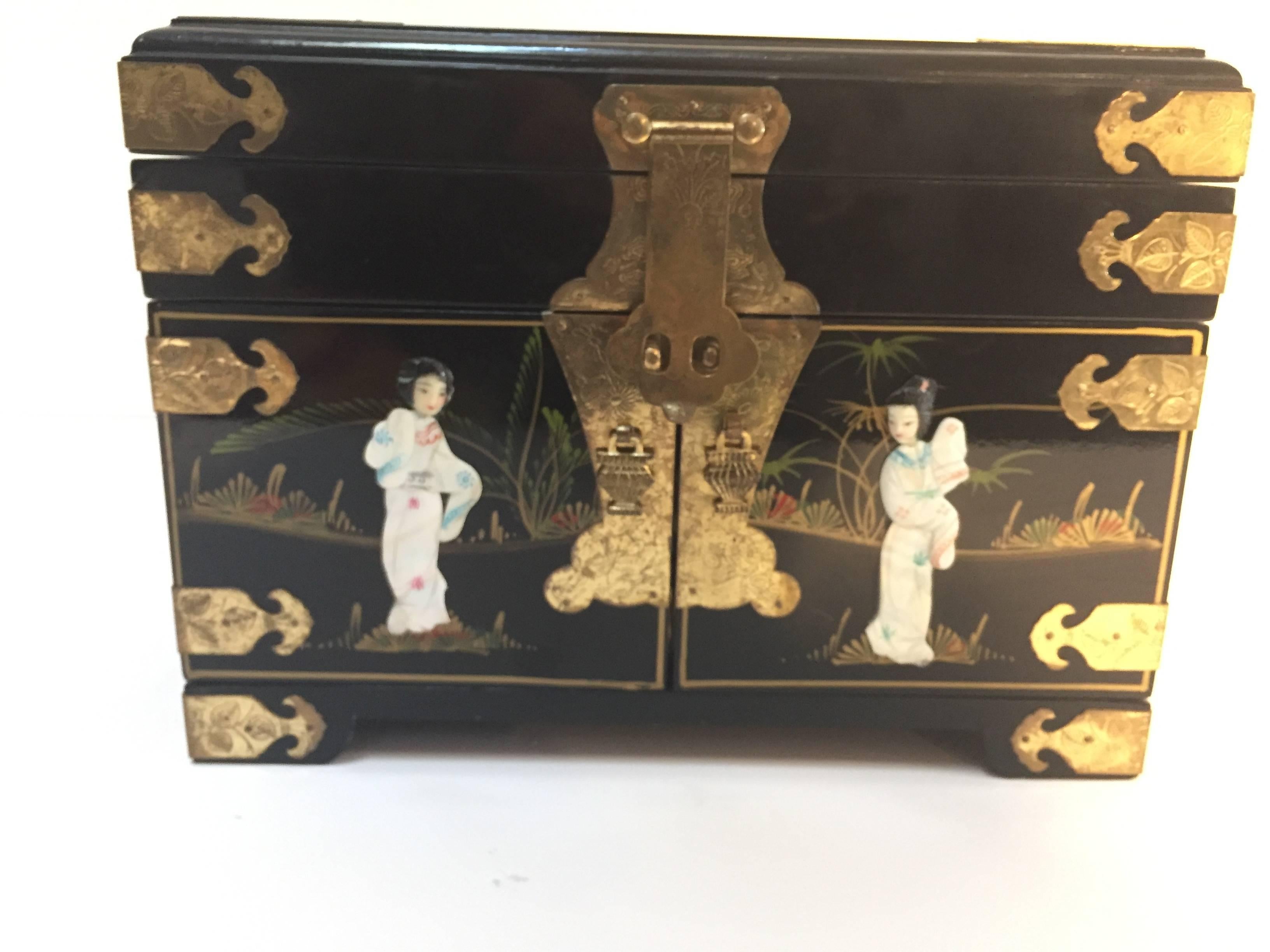 Large Chinese black lacquered jewelry box with mother-of-pearl figurines overlaid on hand-painted black lacquer, this beautiful jewelry cabinet has a mirrored lift-top and double-doors with three spacious drawers.
Chinese tabletop cabinet jewelry