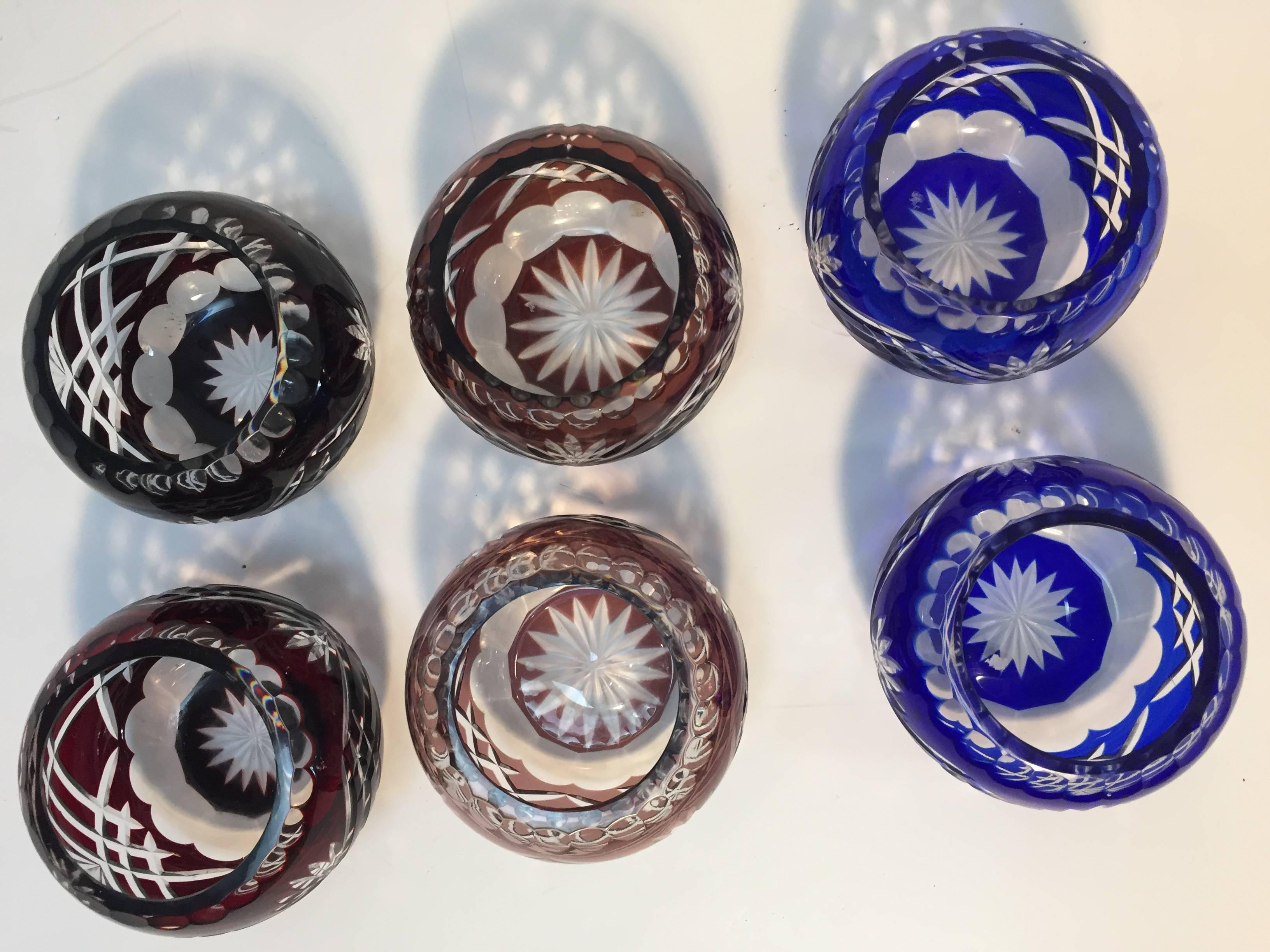Set of six Bohemian cut crystal votives bowls, two in cobalt blue and clear, two in ruby color, and two in wine color.
Colored lead crystal glasses in excellent condition.
 