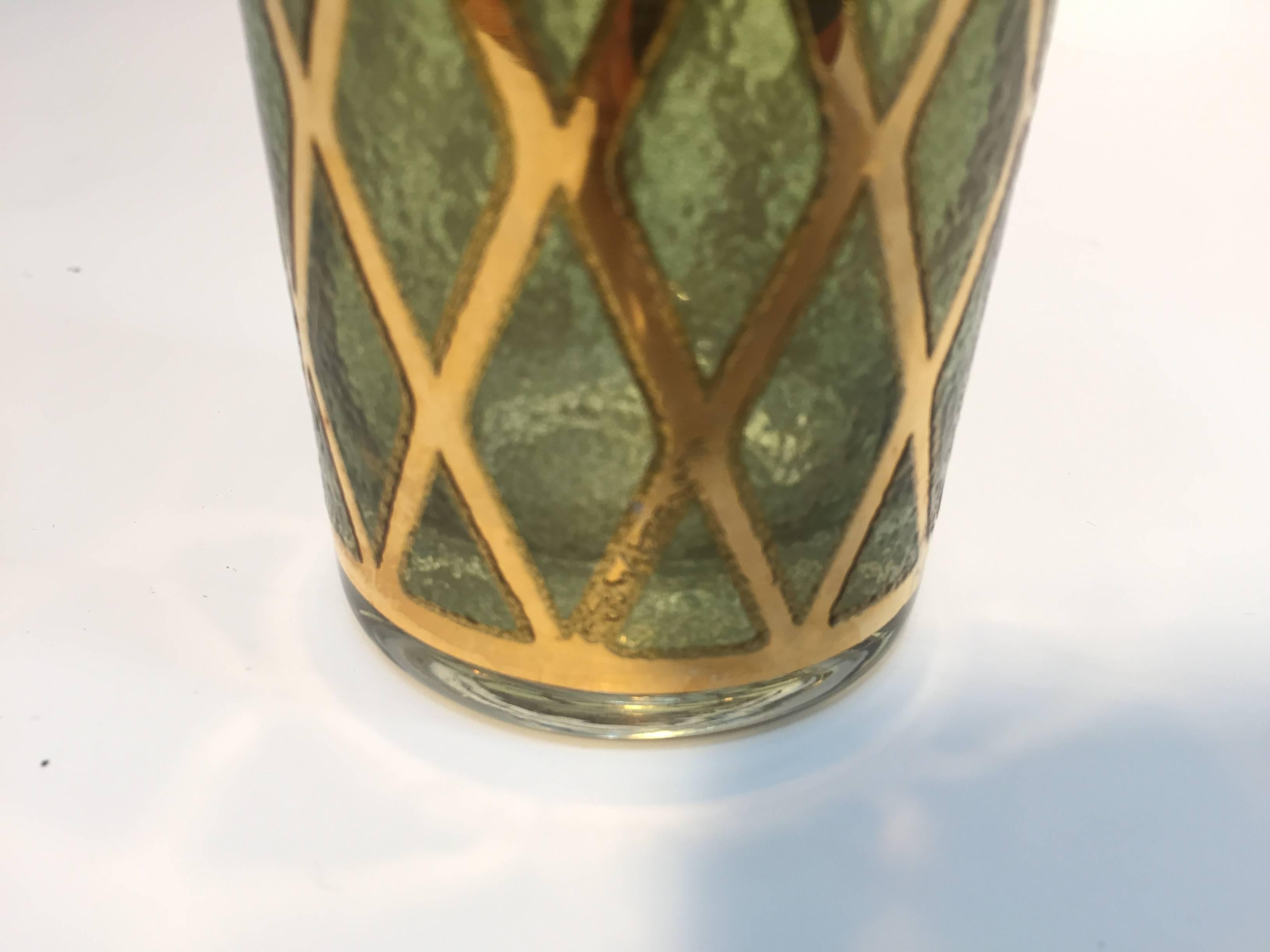 Each vintage cocktail glass is decorated with green and gold designs. 
There are four glasses in the set. 
The gold design and lozenges decorations are in mint condition.
By Culver Ltd, nice to add to any barware cocktail collection,
circa 1960.