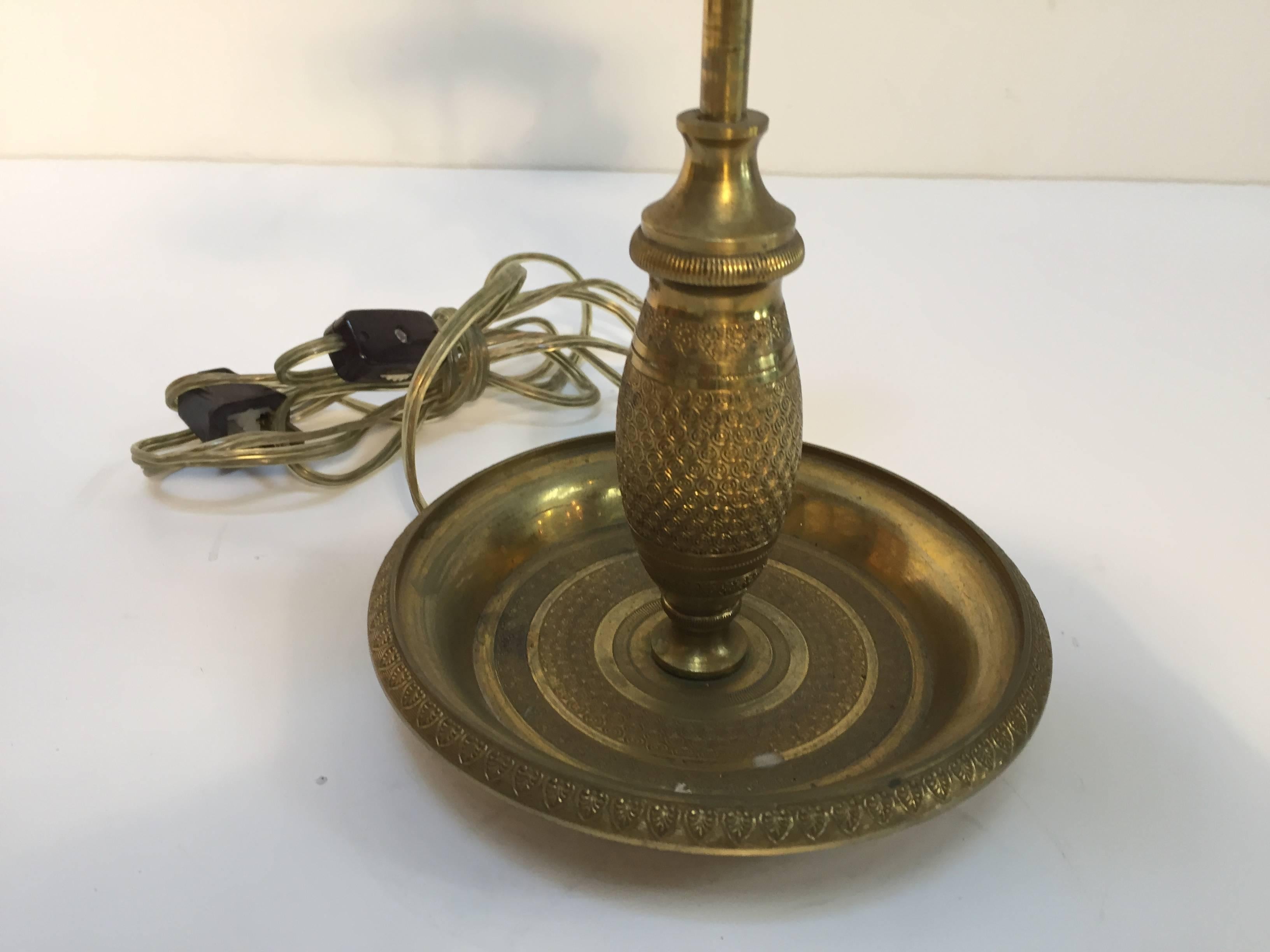 Late 19th century French antique brass candelabra converted into a table lamp.
Three candleholders in brass, nice hammered designs.
Candle height is adjustable.
The candleholders are in form of a swan head holding the brass plate.
The final is