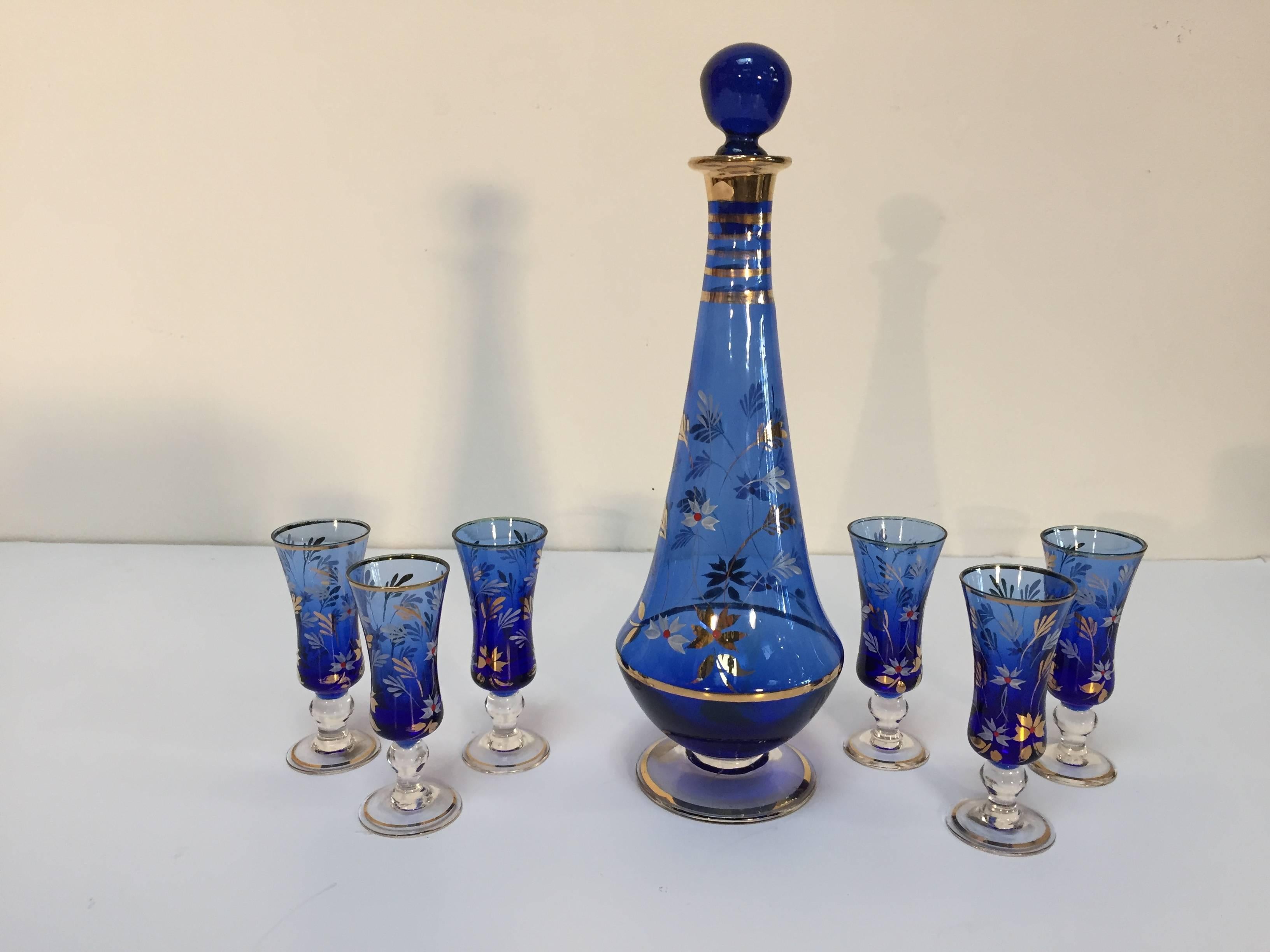 Cobalt blue enameled glass Portuguese liquor set or aperitif service of seven pieces, comprised of a decanter and six glasses.
Mouth blown glass in a stunning electric blue color enhanced with hand-painted enamel.
Measures: 12