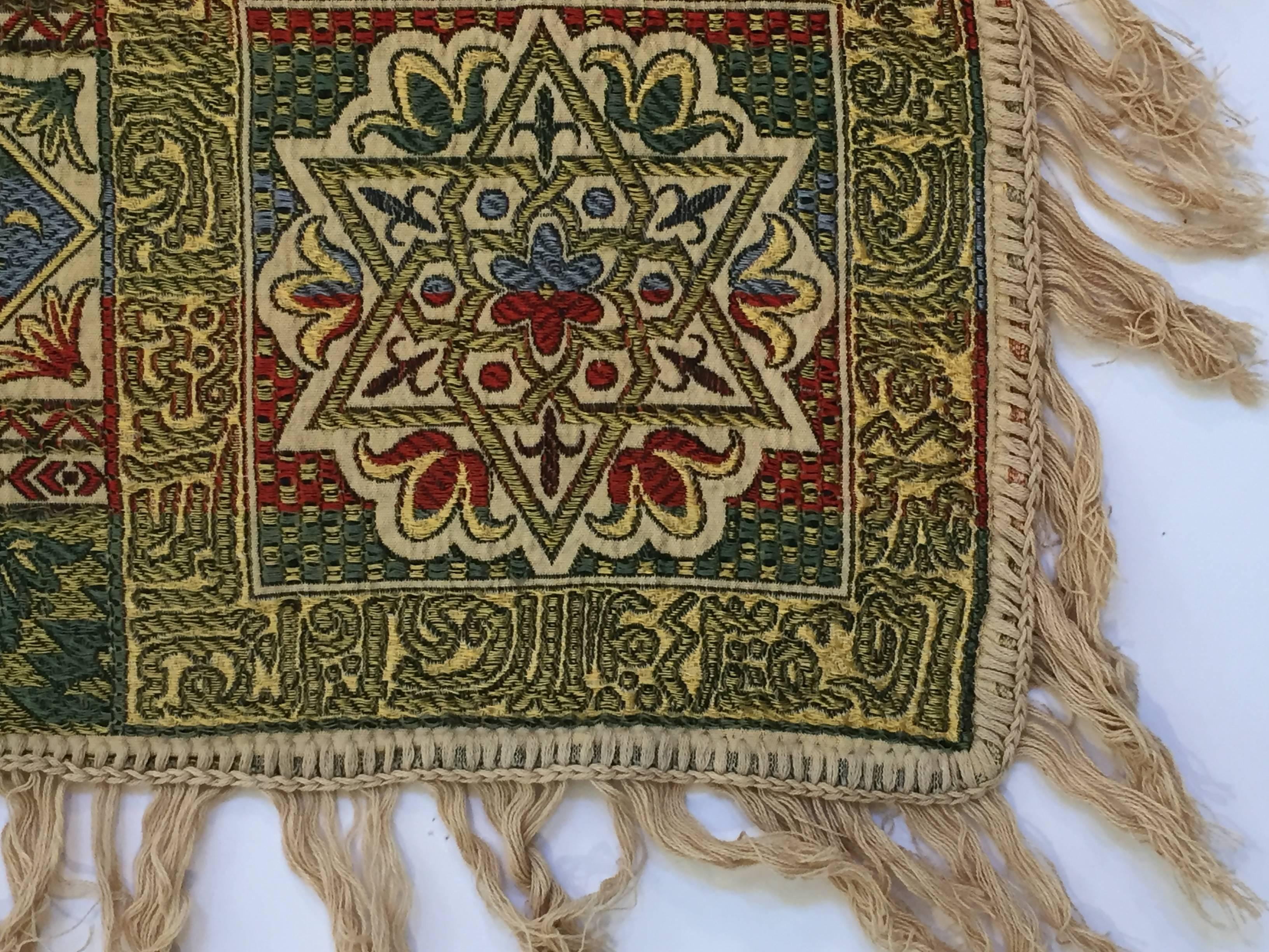 Granada, Islamic Spain, great textile with ivory color fringes featuring Moorish floral and geometric designs with calligraphy Arabic writing.
Colors are earth tone in green, blue, ivory and deep Moroccan red.
Could be used as a piano shawl, sofa