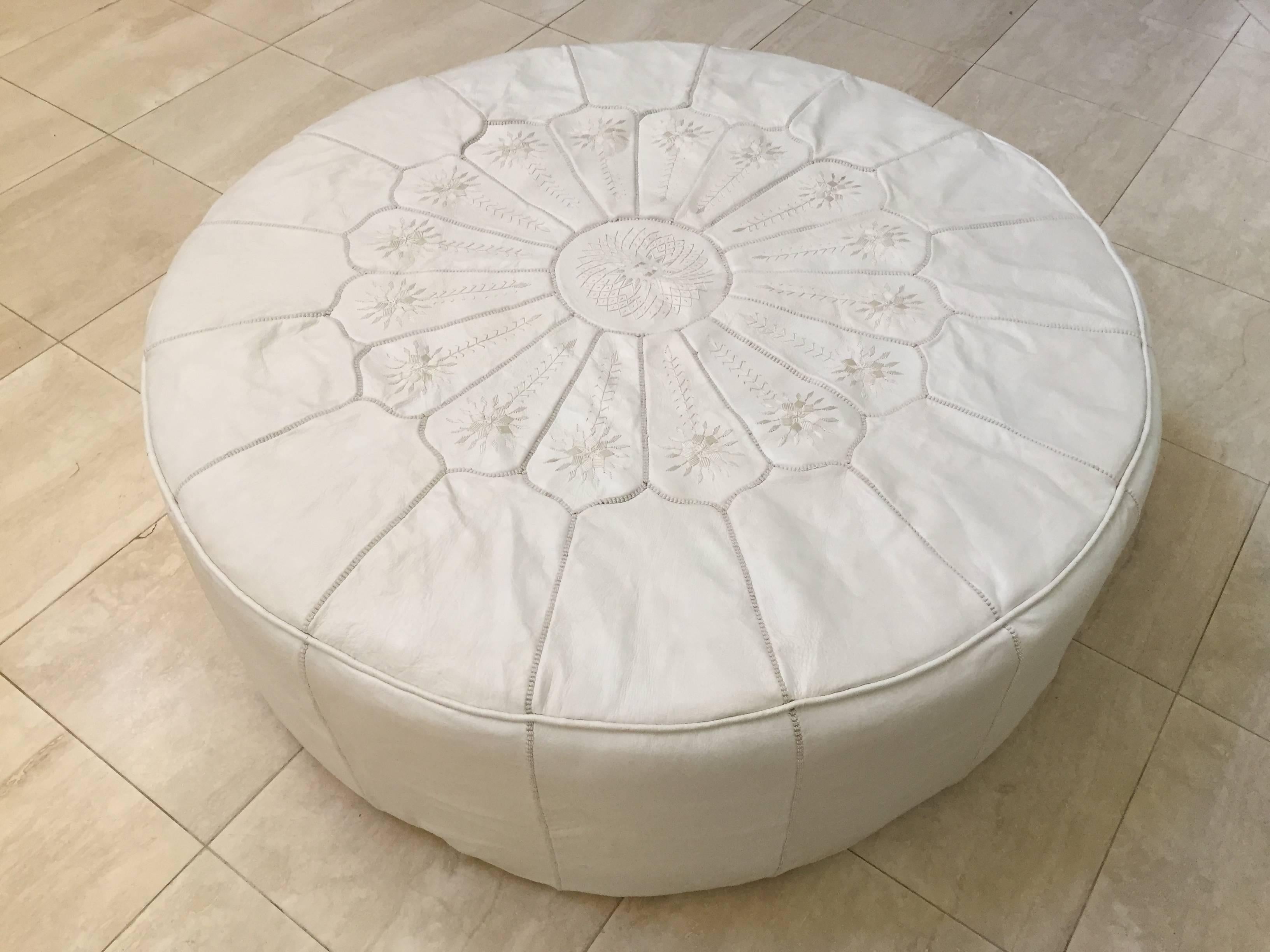Large round white leather table ottoman, handcrafted in morocco by master artisans.
Hand embroidered leather with white silk thread with Moorish designs.
Great to use as a table or large ottoman, pouf.
Designed and created exclusively for