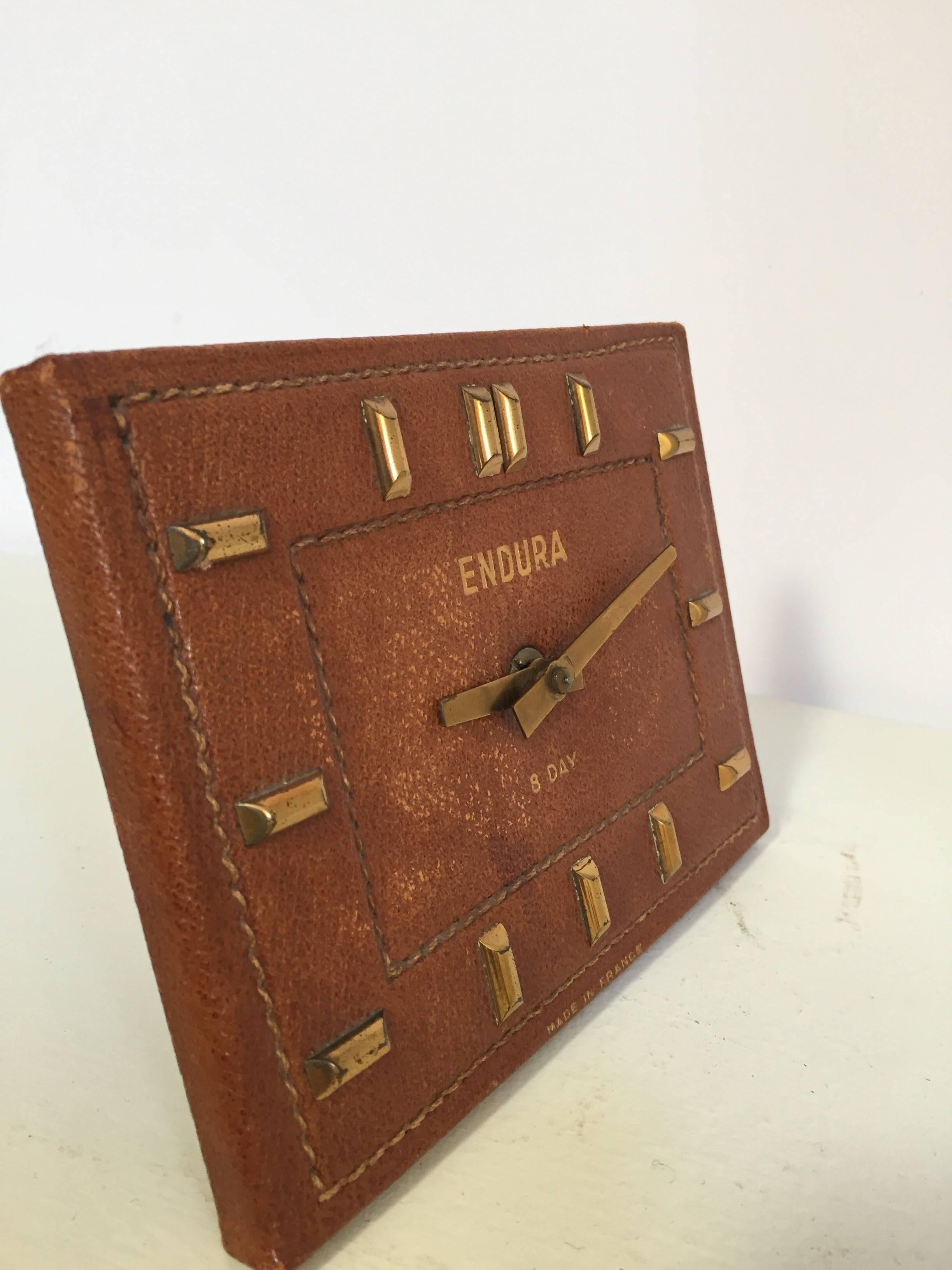 French leather Bauhaus desk clock in the style of Jacques Adnet.
Hand stitched French leather desk clock with brass accent in the style of Adnet.
Marked 