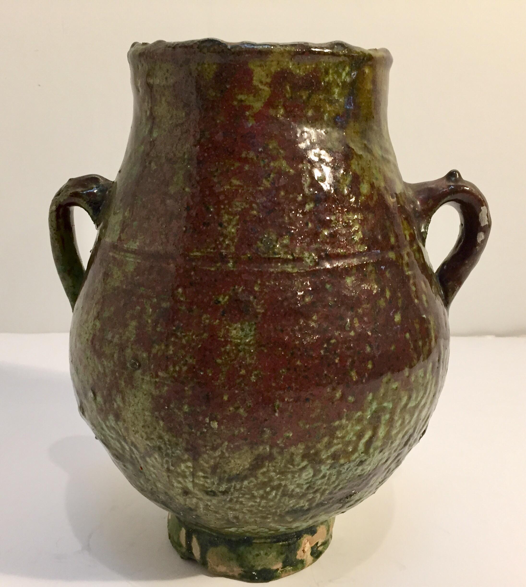 Moroccan Berber green glazed decorative terracotta jar with handles.
Wonderful green shimmering.
These vintage tribal handcrafted green jars were used to store olive oil, vinegar, butter, the larger ones were used for meat and fat.
Size is: 10