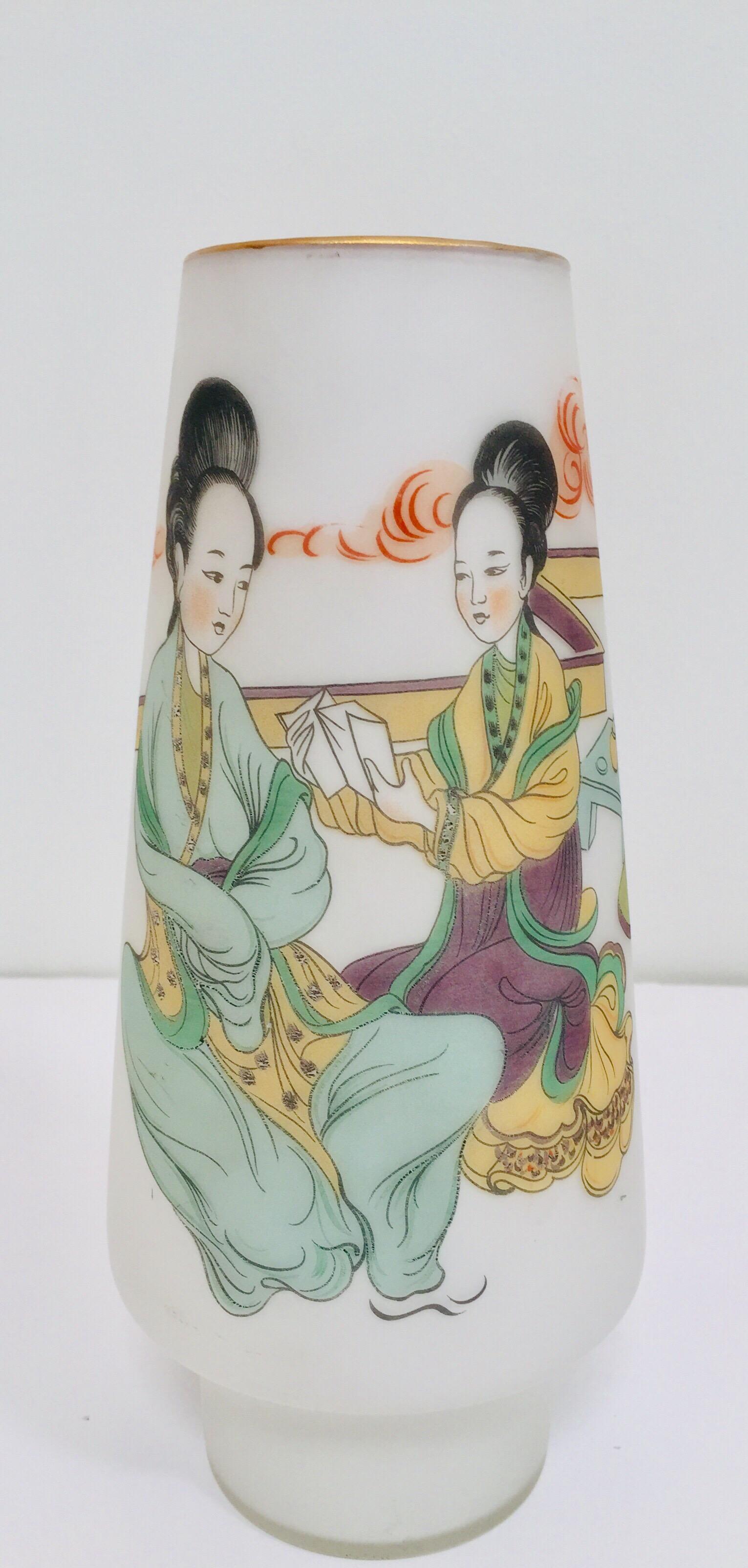 Midcentury Japanese gilded gold rim hand painted opaline glass snow white vase.
The white milky frosted opaline glass vase features two Geisha girls seating on the floor wearing traditional kimonos and reading.
Unique elegant Mid-Century Modern