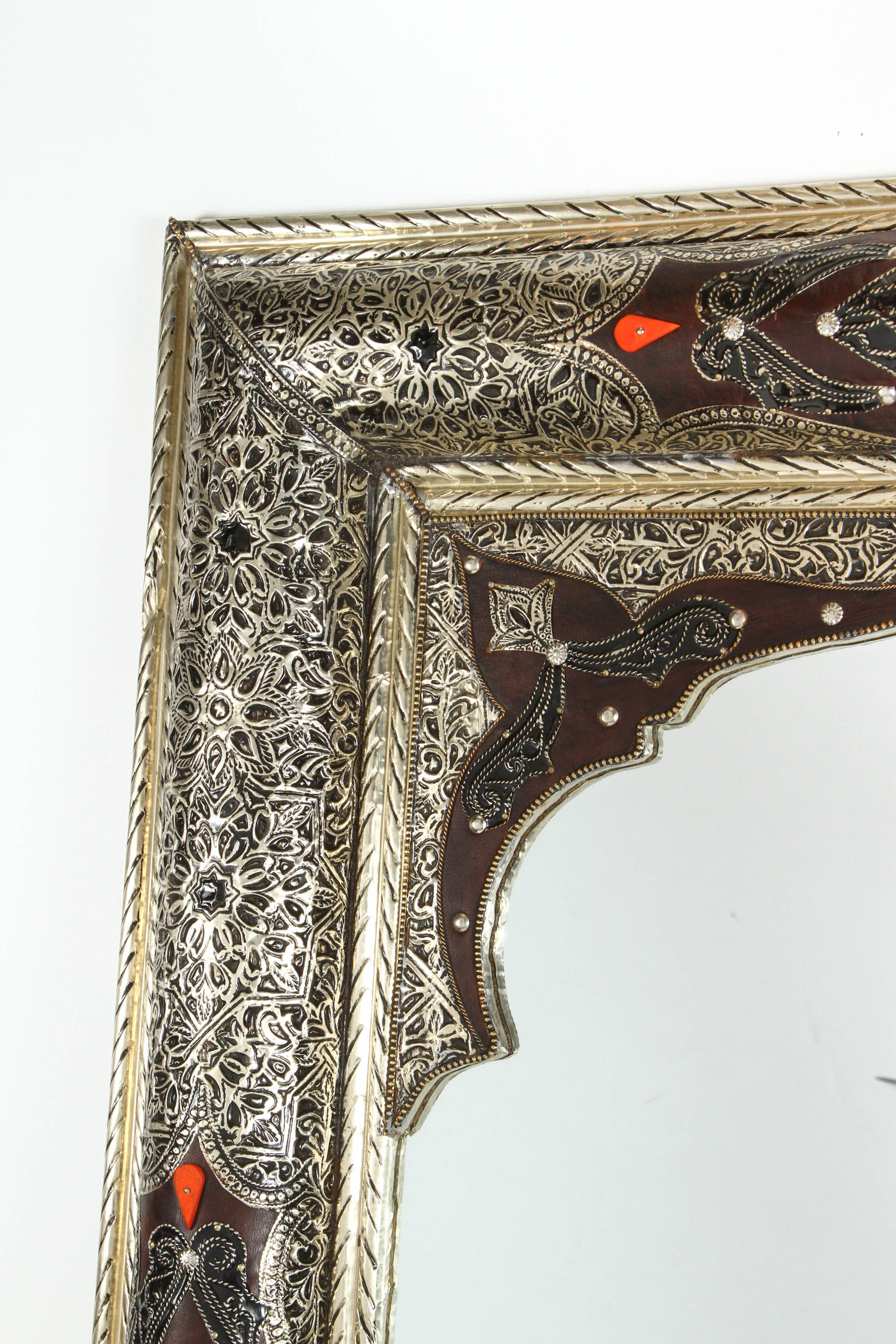 Pair of Elegant Moroccan mirrors decorated with silvered repousse metal delicately engraved and wrapped with leather and amber color stones.
The inside mirror has a Moorish arch in leather and Fine filigree silver décor.
Handcrafted rectangular