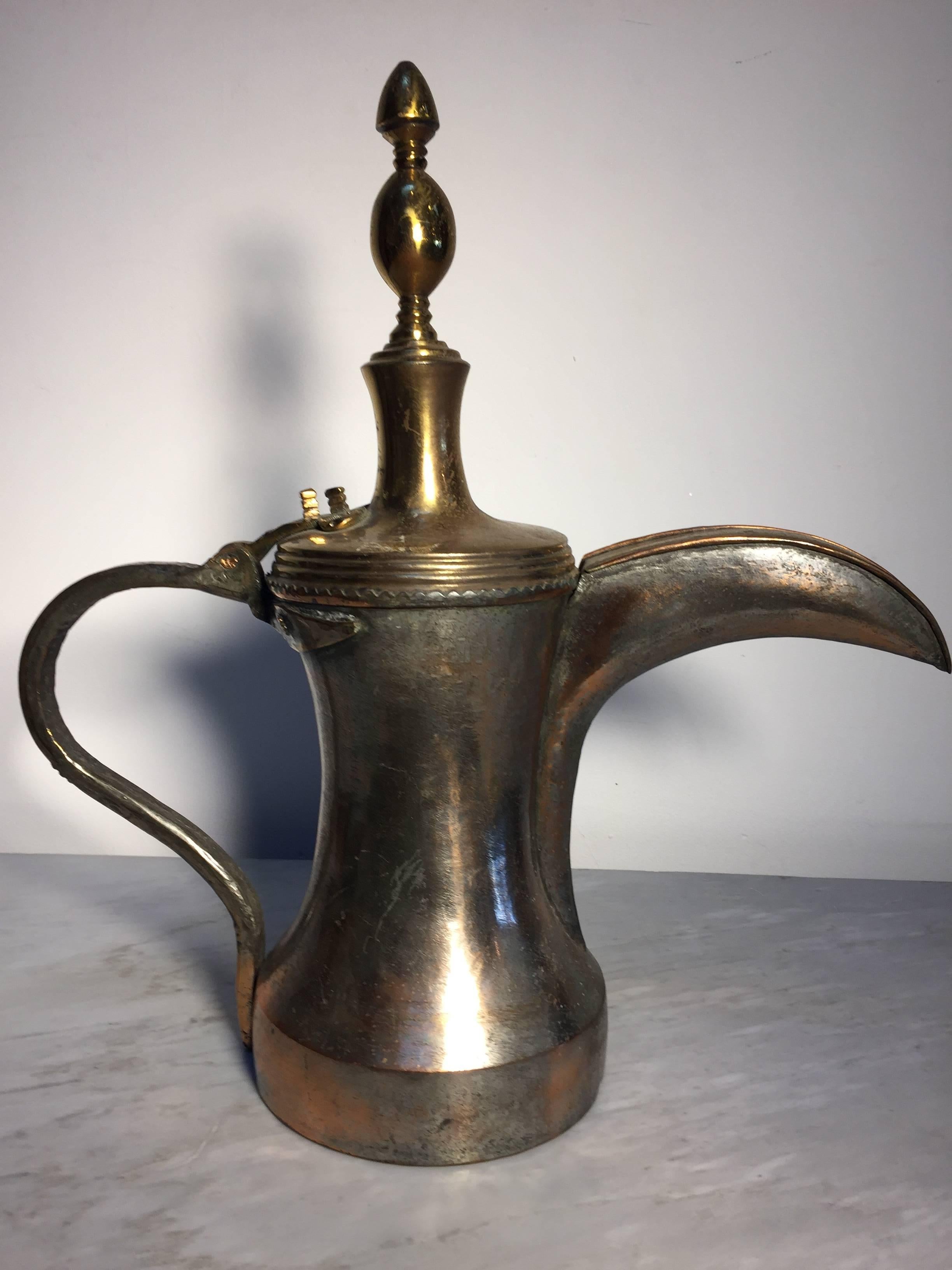 19th century Middle Eastern Dallah traditional Arabian oversized tinned copper Dallah coffee pot. 
Huge oversized decorative coffee pot hand-hammered and chased copper with riveted brass finish and a very large spout. 
Size: 19