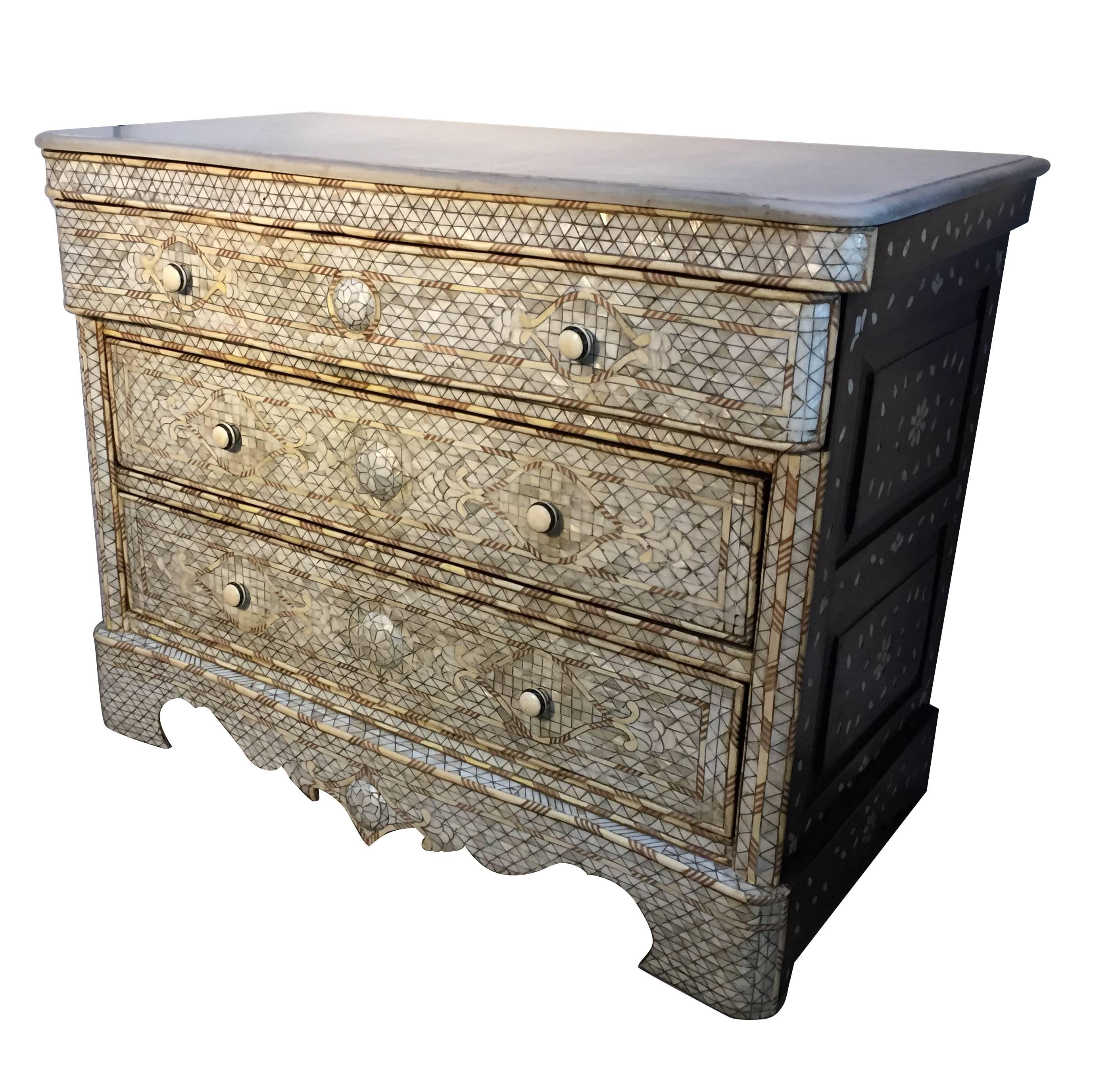 Fabulous Middle Eastern Syrian art work, handcrafted white wedding dresser with three drawers, wood inlay with mother-of-pearl, shell and bone. Moorish arches and intricate Islamic designs. 
Dowry chest of drawers heavily inlaid in front, the sides