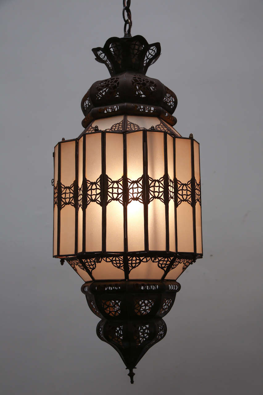 Elegant and stylish milky white glass handcrafted Moroccan lantern with intricate metal filigree open work in the Moorish style.
Hispano Moresque style pendant will add elegance in any room.
Rewired in the US with a single light source one socket,