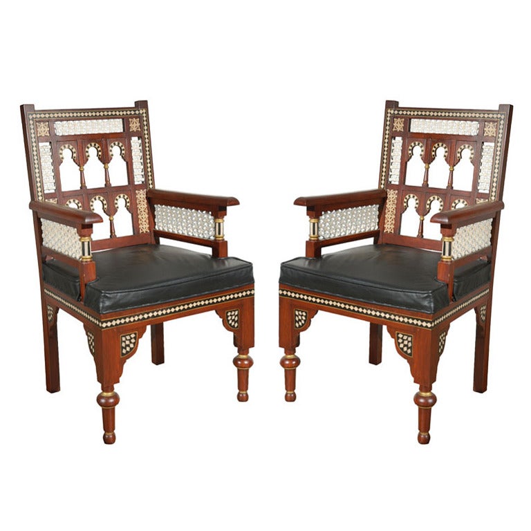 Pair of Egyptian armchairs with faux leather seat cushion with Moorish lattice fret work on side and back with Moorish arches design in the style of Carlo Bugatti.
Hispano Moresque style, Alhambra design with Moorish Islamic arches in black and