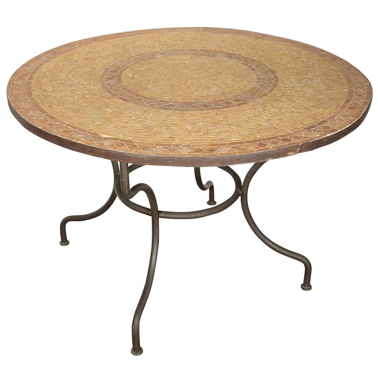 A inlaid round stone Moroccan mosaic tile tabletop on an wrought iron base.
Handcrafted in Morocco could be use indoor or outdoor.
Spanish Moorish garden dining mosaic table in the style of Bill Willis Marrakech.
The top is not attached to the