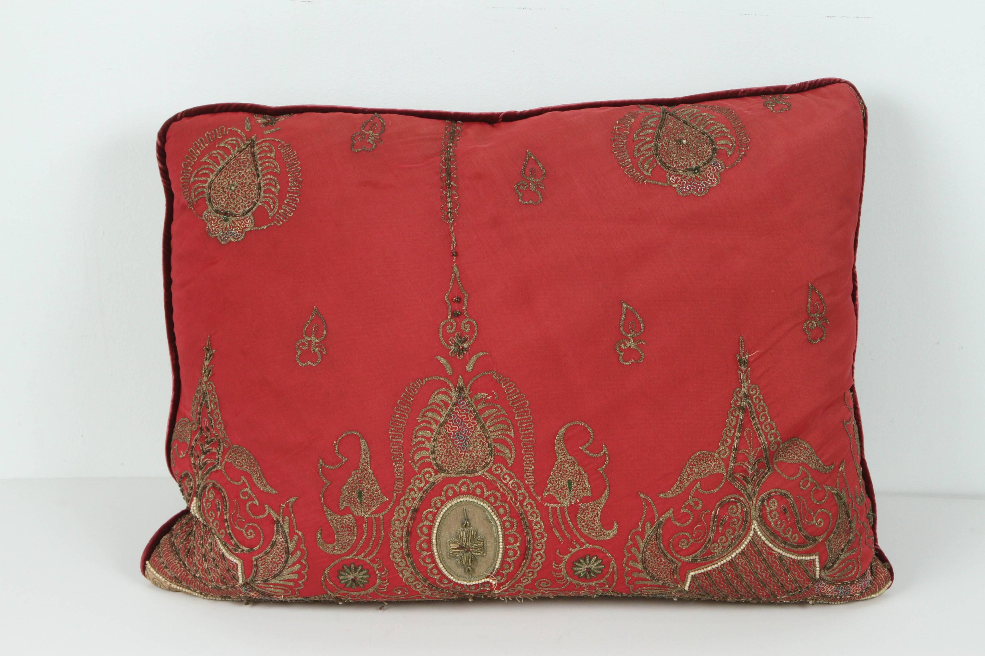 Pair of antique silk pillows with metallic threads and dark burgundy velvet backing.
Pair of handmade silk pillows made from an antique 19th century Turkish silk embroidered panels with gold metallic thread and pearls.
Down filled and only a pair