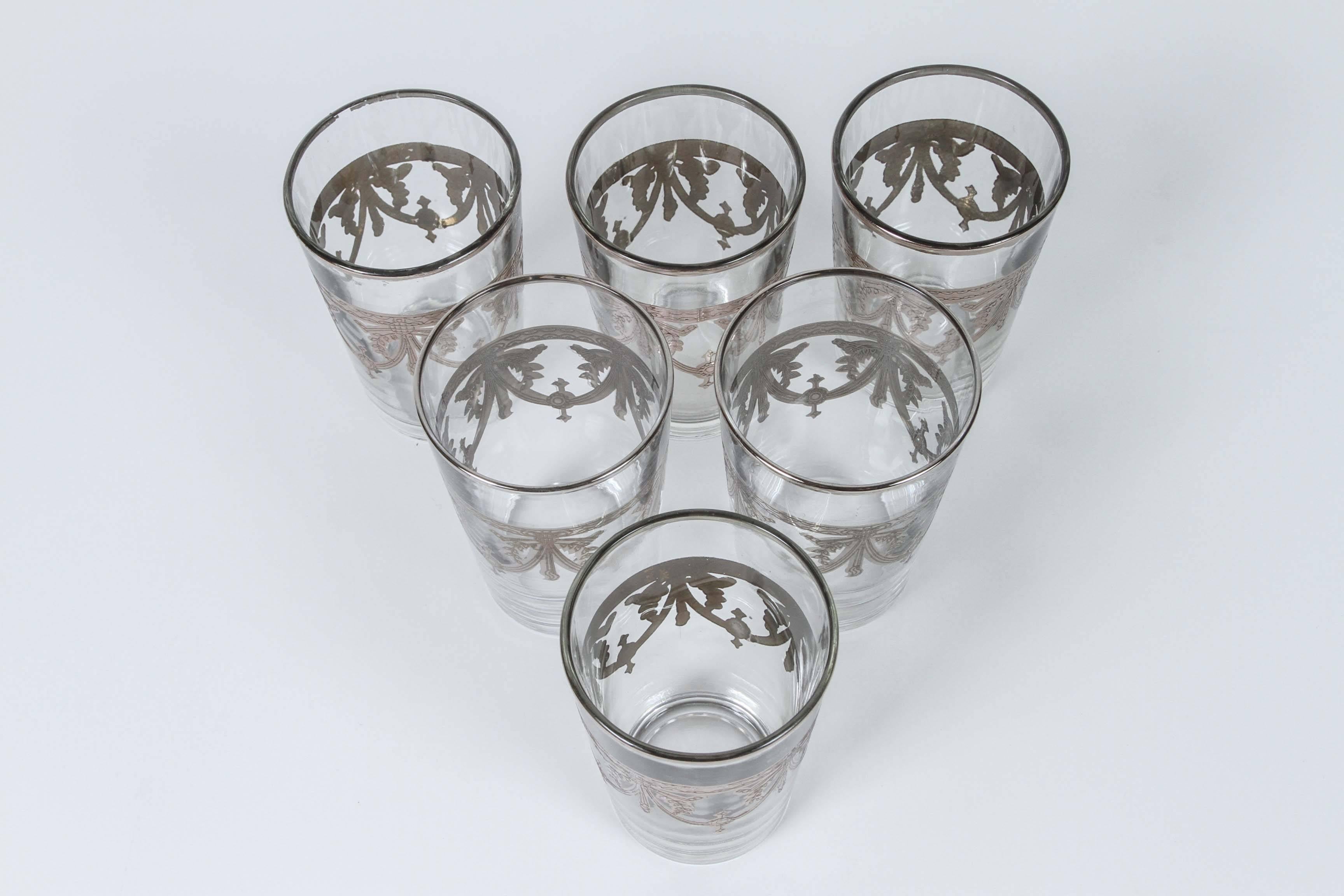 Set of six clear glasses with silver overlay raised Moorish designs.
Decorated with a classical silver pattern overlay frieze.
Use these elegant glasses for Moroccan tea, or any hot or cold drink.
In fantastic condition, perfect for the holidays and