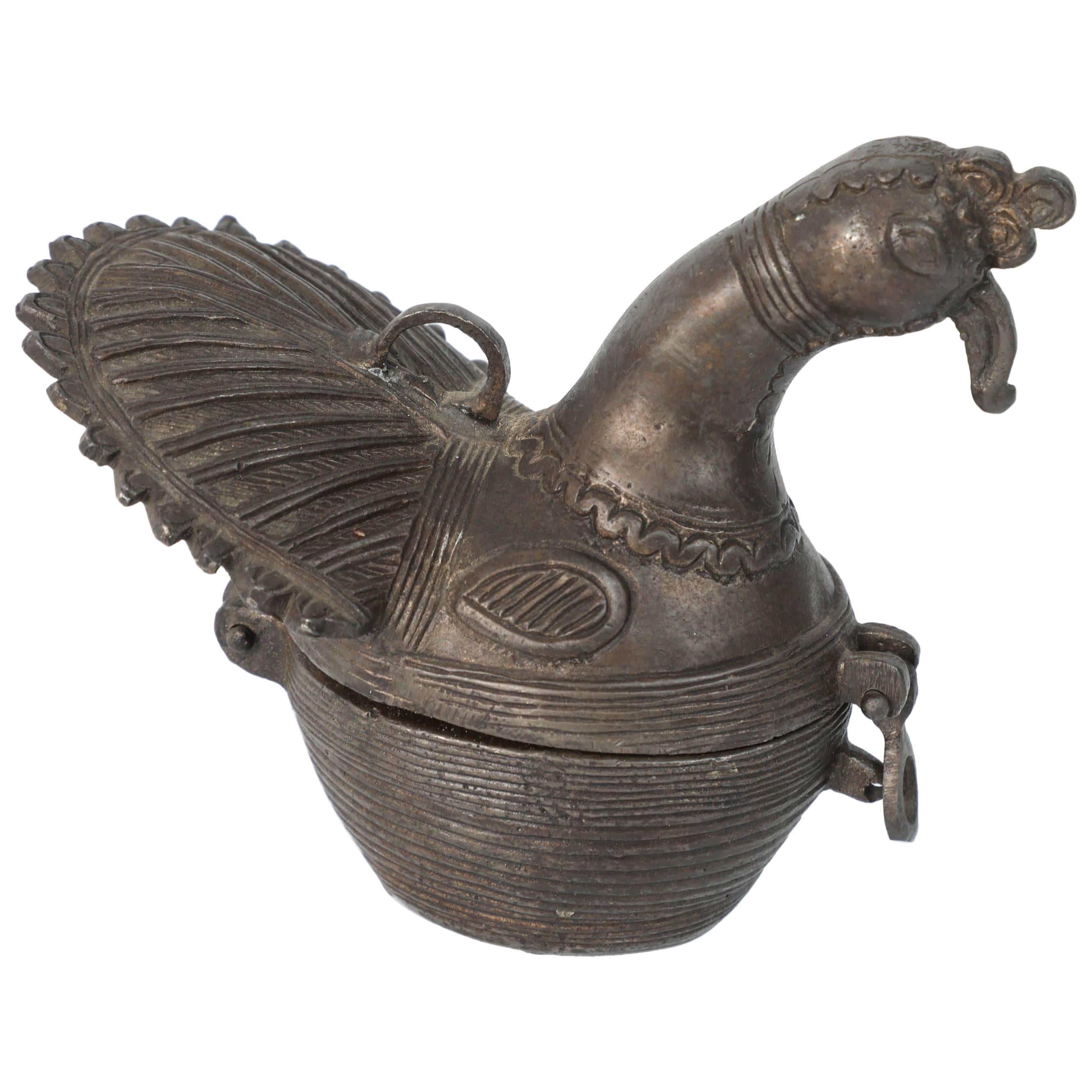 This is an antique patinated bronze sculpture of a stylized form peacock. 
Used as a betel box or tobacco opium box.
Produced using the traditional 'lost wax' process.
Great Asian Islamic Folk Art, Mughal India.

  