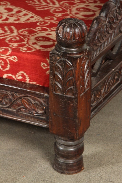 Great large Anglo Raj Indian daybed.
Teak wood, dark finish, hand-carved all-over, and designed with fret work and Moroccan Moorish arches in the back.
Newly reupholstered. Great Spanish Portuguese colonial style, hand-crafted in Rajasthan, India.