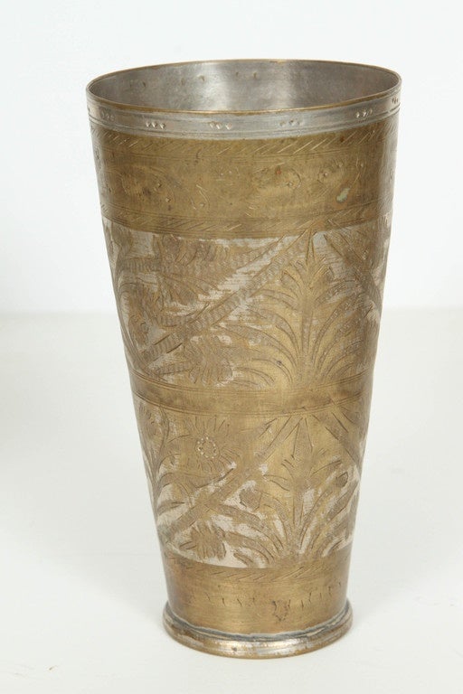 Great decorative antique Middle Eastern Engraved Brass Beakers.
Late19thc.
Nicely hand chiseled and hand-carved with floral motifs.
Use them as vases for flowers, great accent Anglo Raj decorative objects.
Set of 5.
4 larger ones are 7" height
