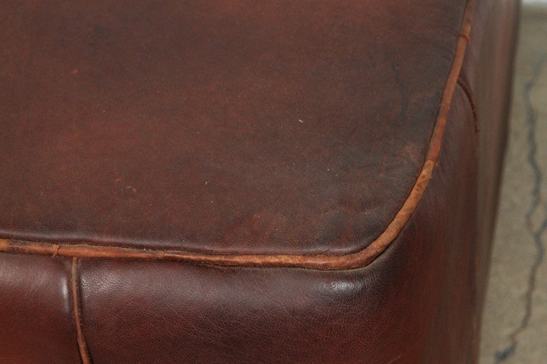 Large Moroccan square leather pouf, hand-crafted in dark brown camel leather.
This ottoman is filled with foam, use it as a footstool or nice accent piece.