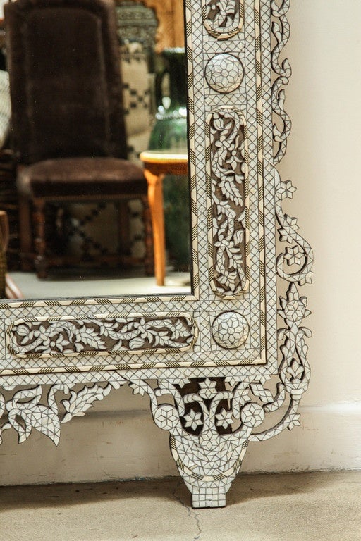 Palatial oversized Middle Eastern Syrian intricately ornate and inlaid with white mother of pearl, shell, ebony, camel bone, 10 feet height.
A large Damascus mother-of-pearl inlaid wood Mirror of rectangular form with feet and tapering crest,