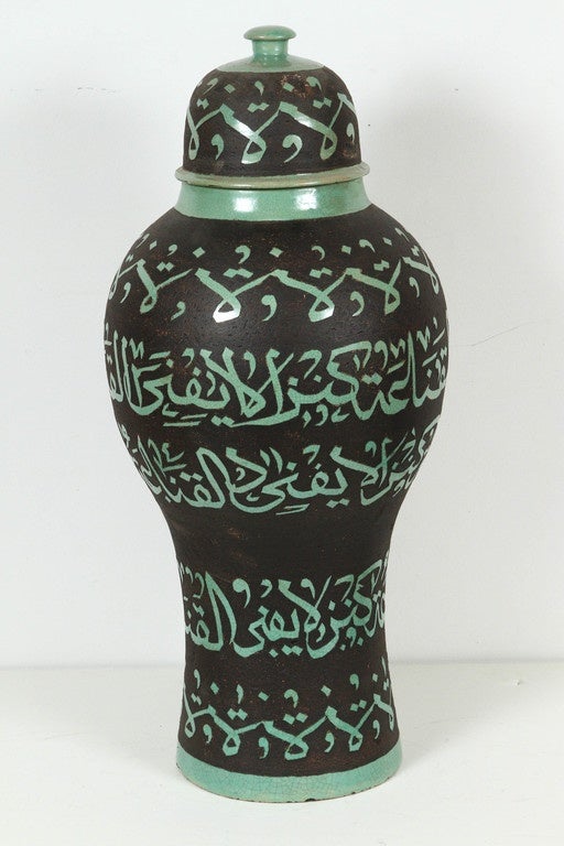 Large Moroccan green ceramic urns with lid chiseled with Arabic Calligraphy poetry writing.
Handcrafted in Fez Morocco, etched green ceramic on brown background.
This kind of Art Writing looks calligraphic is called Lettrism, it is a form of art
