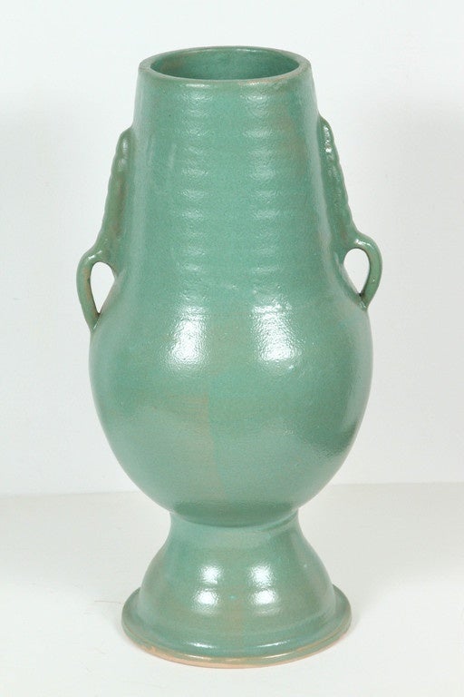 Pair of footed Moroccan turquoise teal color handcrafted ceramic vases with handle.
Size: 22 in H.
12 in Diameter for the widest part.
Top: 6.25 in. D.
Bottom diameter : 8.5 in.D.
Some similar pieces could be seen in Doris Duke Shangri LA Hawaii