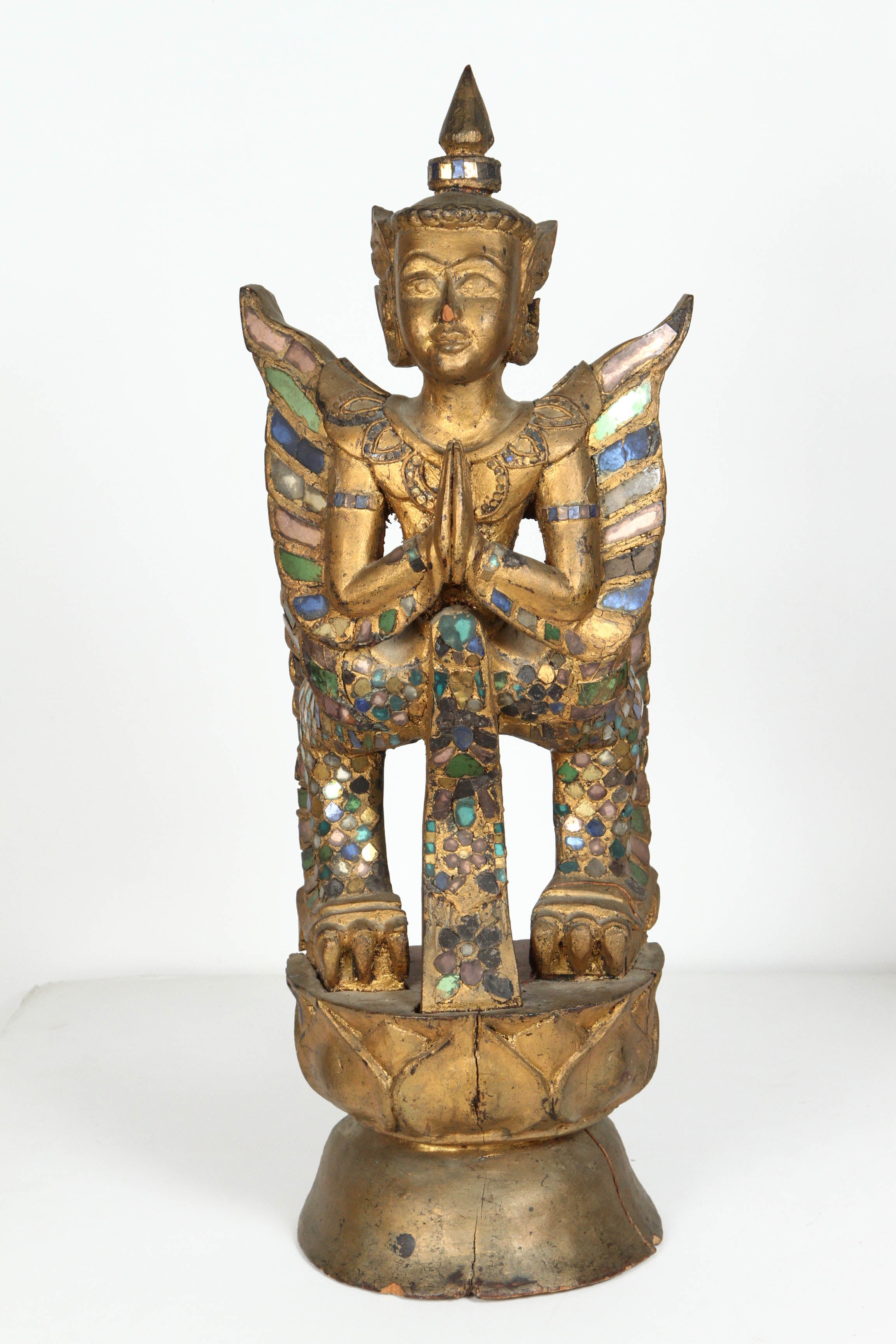 South Asian hand-crafted Gilded wooden Thai Kinnaris sculpture adorned with green and clear mirrored gem pieces to reflect the light.
Half bird half human divinity in South Asian mythology Kinnaree is depicted as half-woman, half bird, she has the
