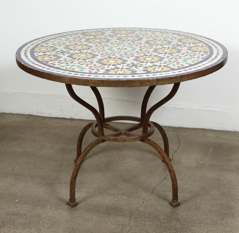 Great Moroccan mosaic tile table, delicately handcrafted in Fez with traditional Islamic Moorish designs in white, blue, red, green colors, black, the tile table sit on an iron hand-forged base in rust color. Great to use indoor or outdoor.