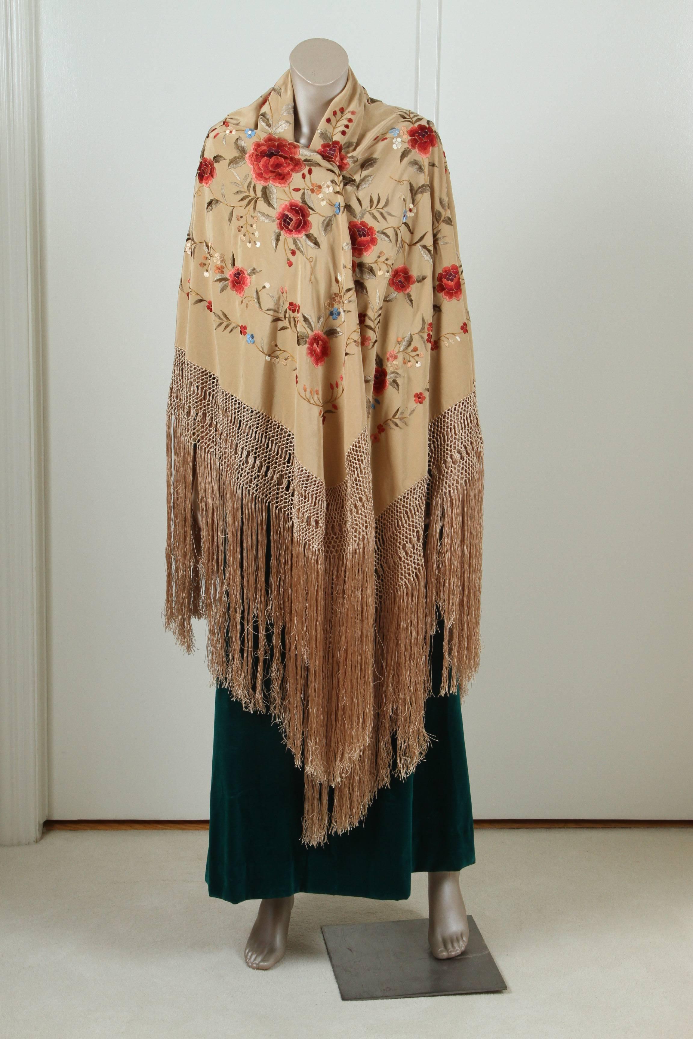 A gorgeous Spanish floral hand embroidered silk shawl with a long knotted fringe on all four sides.
This extraordinary wedding Flamenco silk shawl is completely hand embroidered, covered with amazing polychrome florals and foliage. Wonderful quality