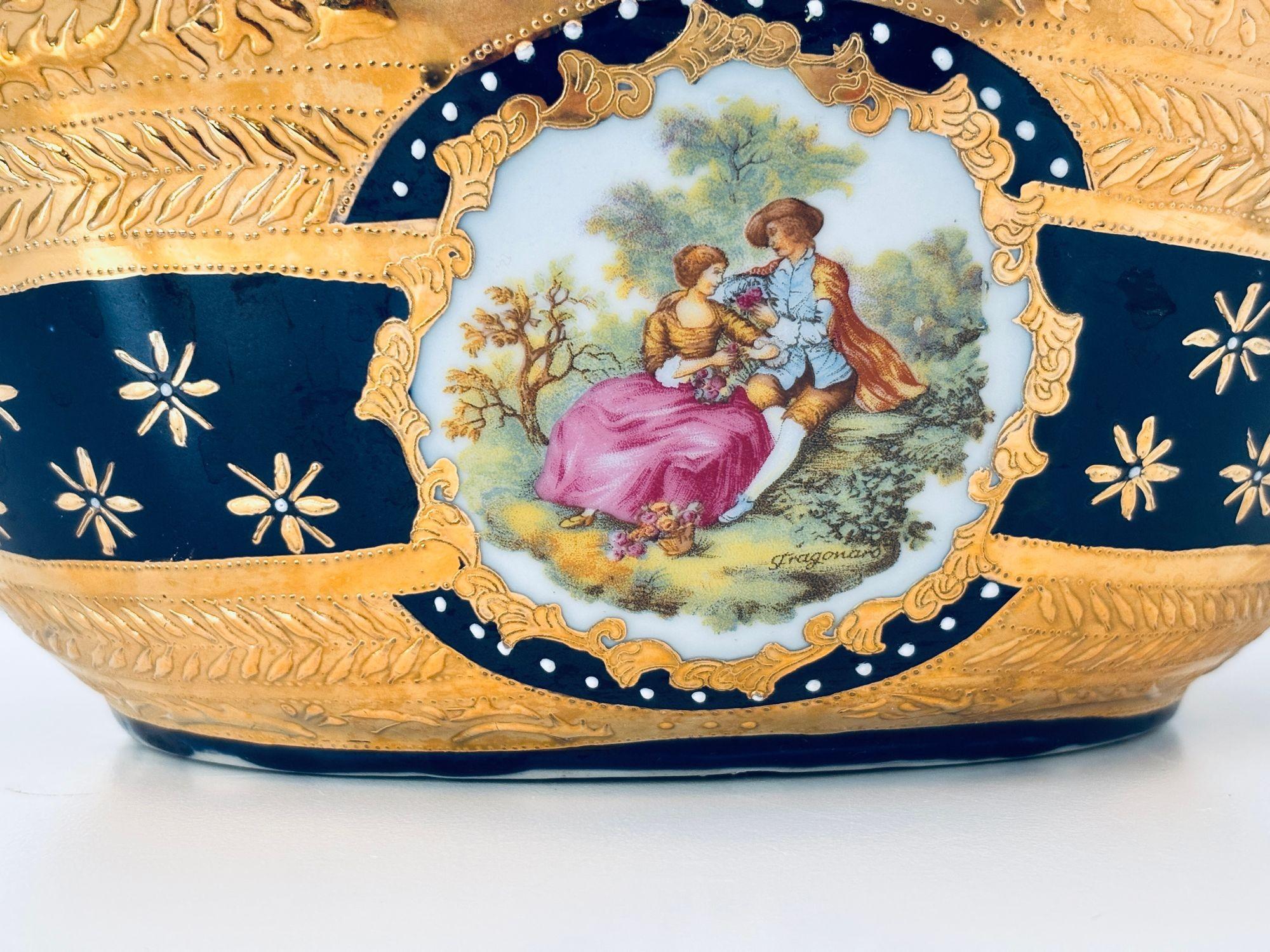 Vintage Large Cobalt Blue Porcelain Basket Vase with 22K Gold Encrustation and Romantic Scene in Limoges Style
Elevate your decor with this exquisite large vintage porcelain basket vase, beautifully styled in the tradition of Limoges porcelain.
Hand