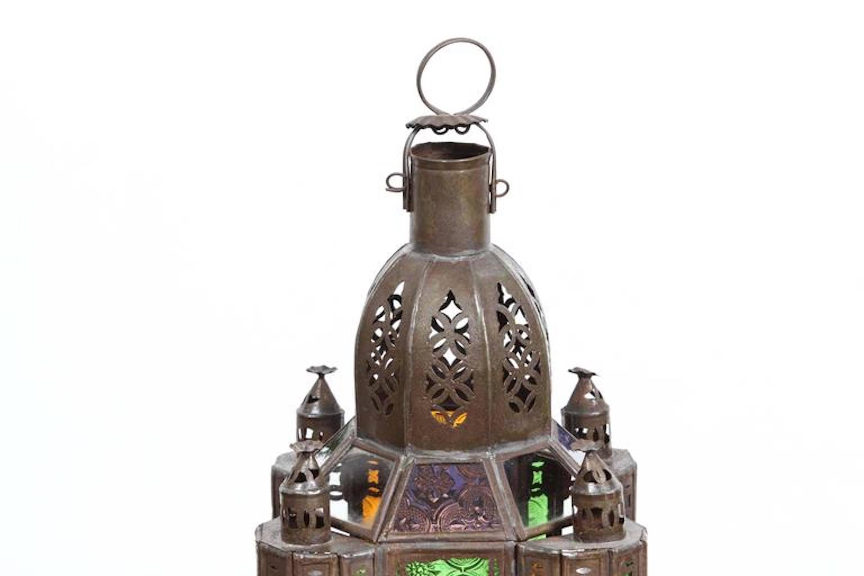 Handcrafted small Moroccan glass lantern or Moorish pendant.
Multicolor molded glass in green, lavender, blue and clear.
Hurricane candle lamp handmade in Marrakech, vintage metal in rust color finish.
Nice Moorish shape, could be used as a candle