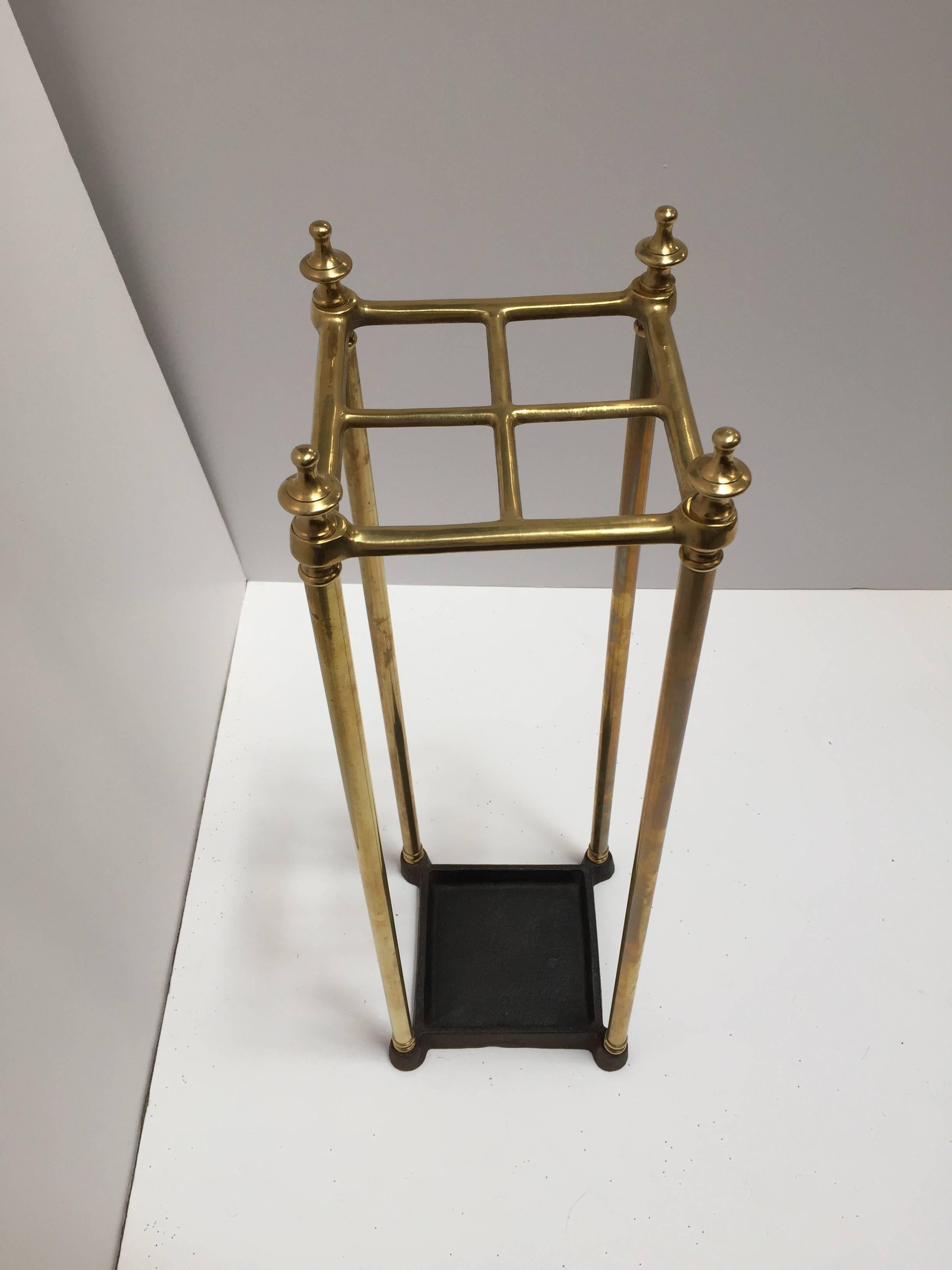 Fine mid-19th century Victorian umbrella stand with a brass top divided into four sections to hold either walking sticks or umbrellas.
Square umbrella brass valet rack with four sections and iron tray and supported upon a tubular frame with turned