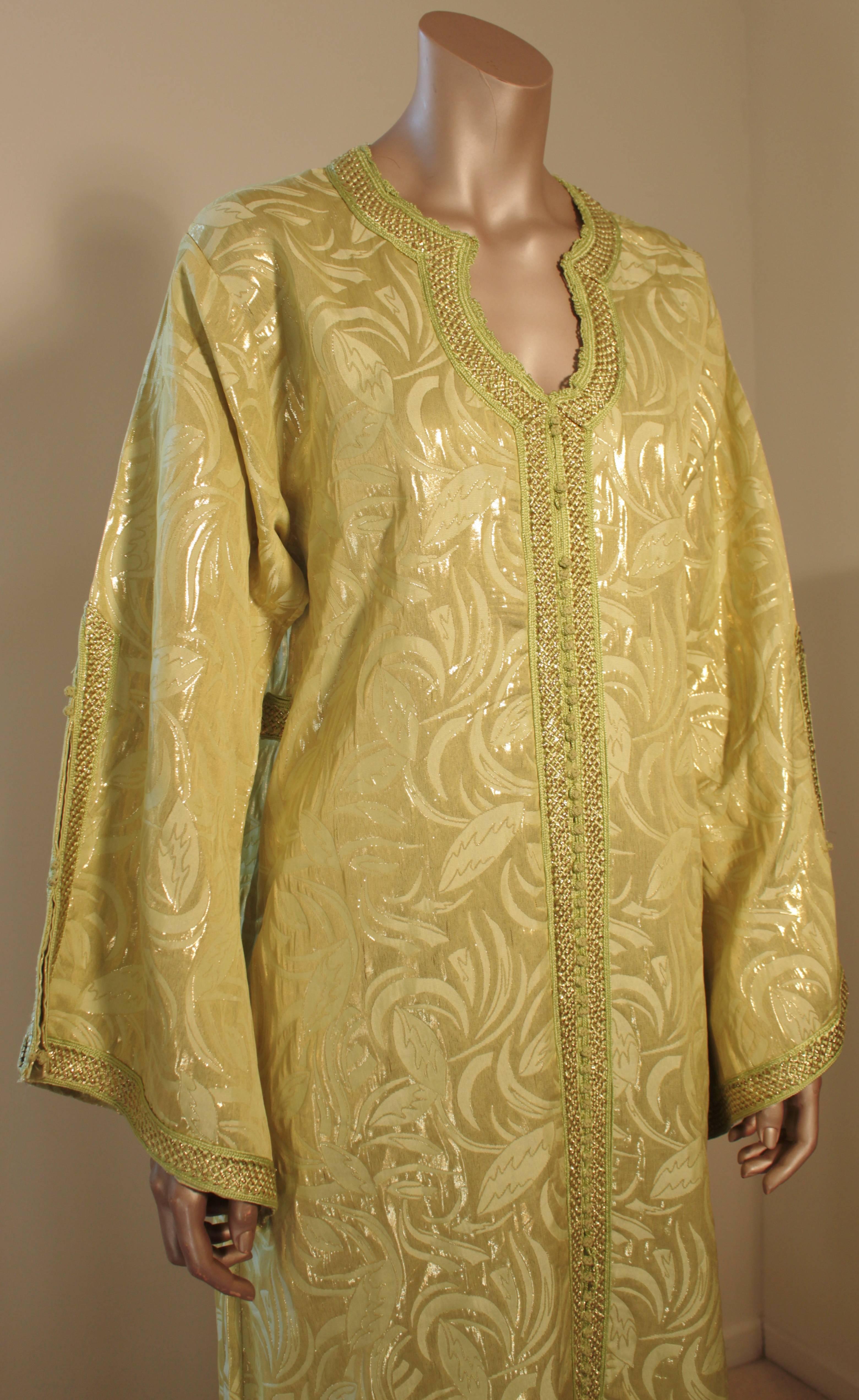 Moroccan vintage exotic metallic brocade caftan gown, circa 1970s.
The luxurious Moorish kaftan is designed with brilliant gold and green metallic brocade and green embroidered.
The front of the elegant caftan gown is embellished at the front with