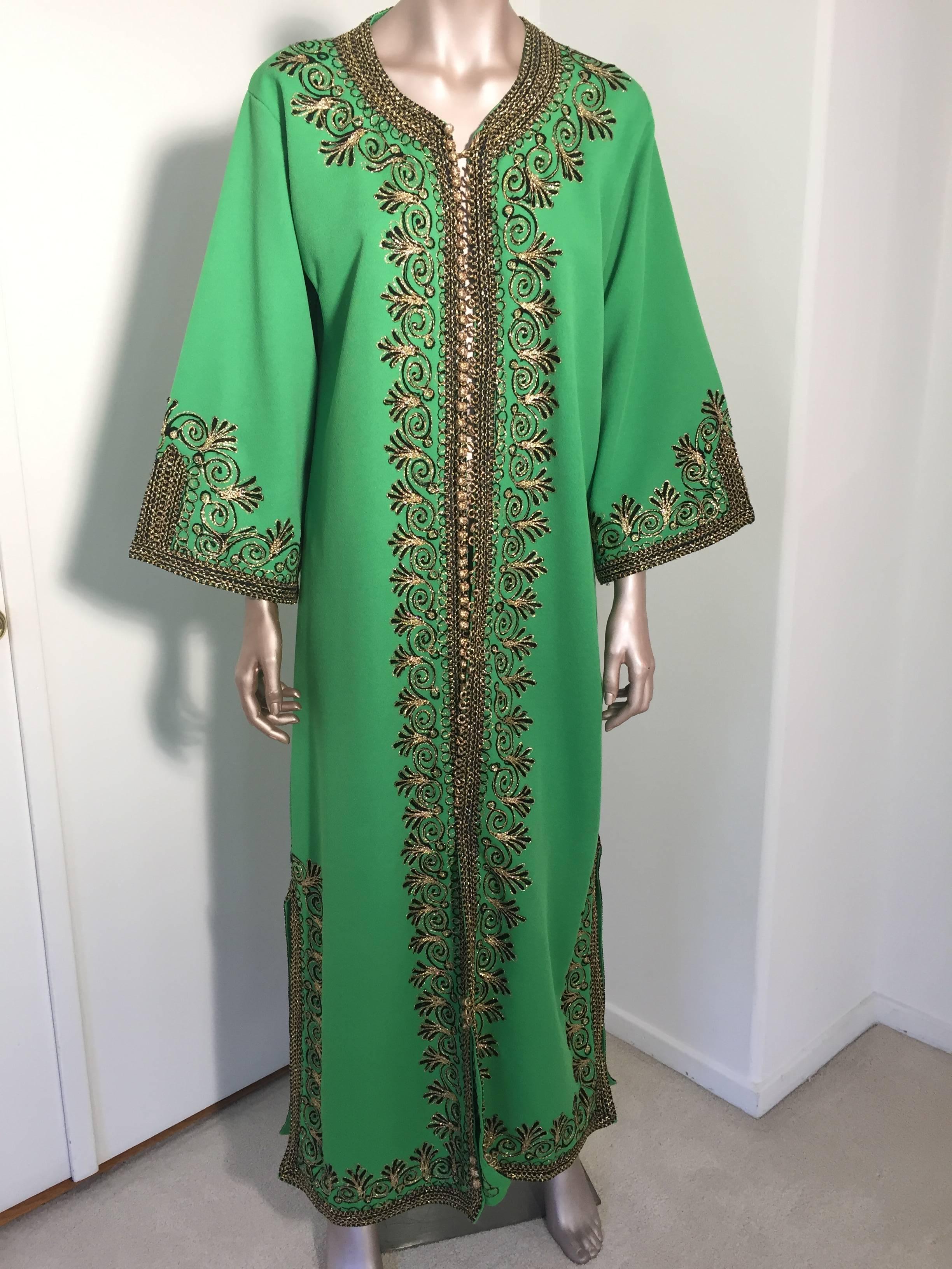 Elegant vintage Moroccan green caftan, poly jersey embroidered with black and gold threads design all-over. 
You could wear this maxi dress kaftan closed or open like a coat. 
The kaftan features a traditional neckline, with side slits and gently