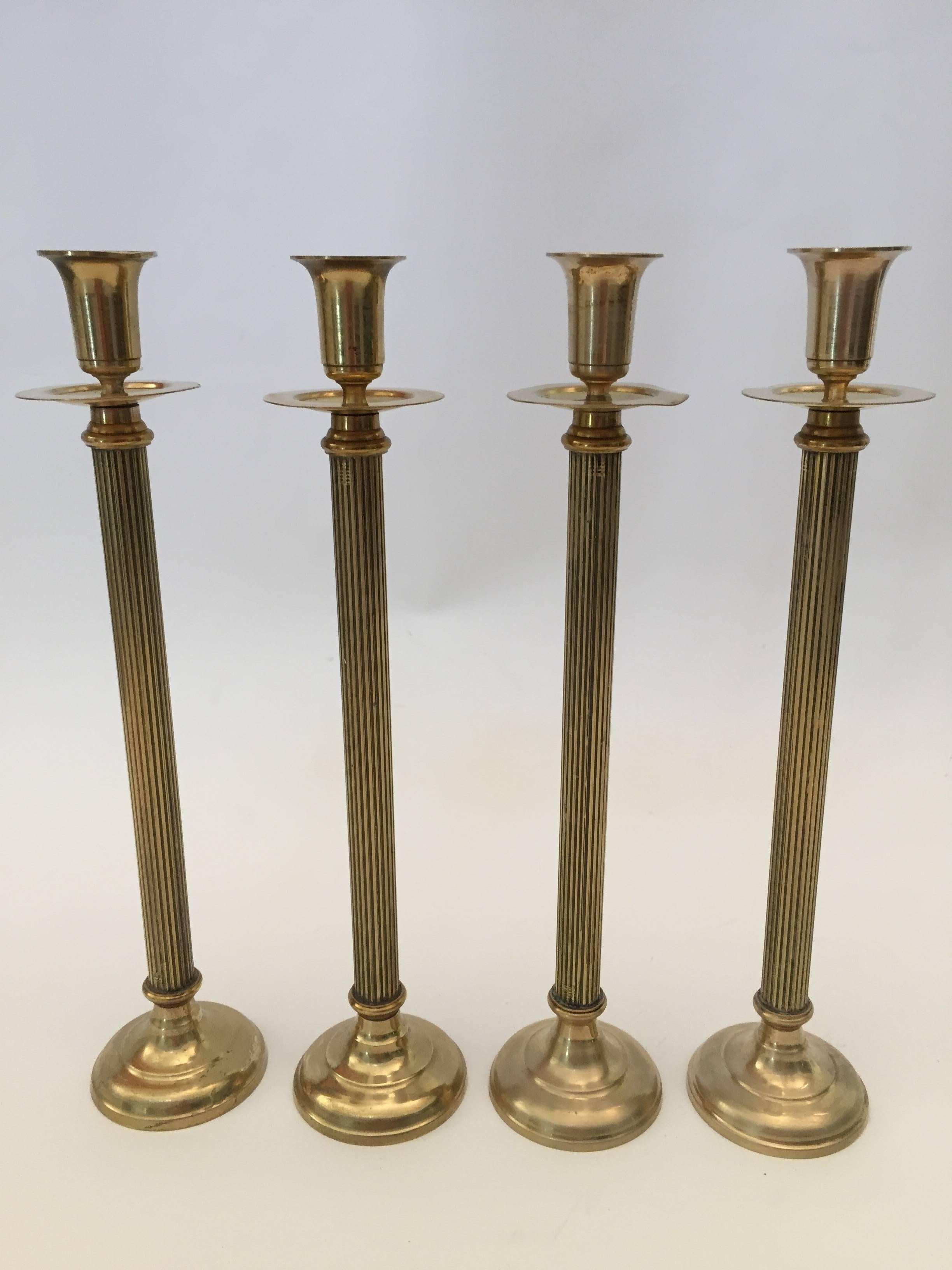 Set of four Victorian brass candlesticks.
Round base. Drip pan near sockets.
Measures: Height 13.5”, base 3”.
