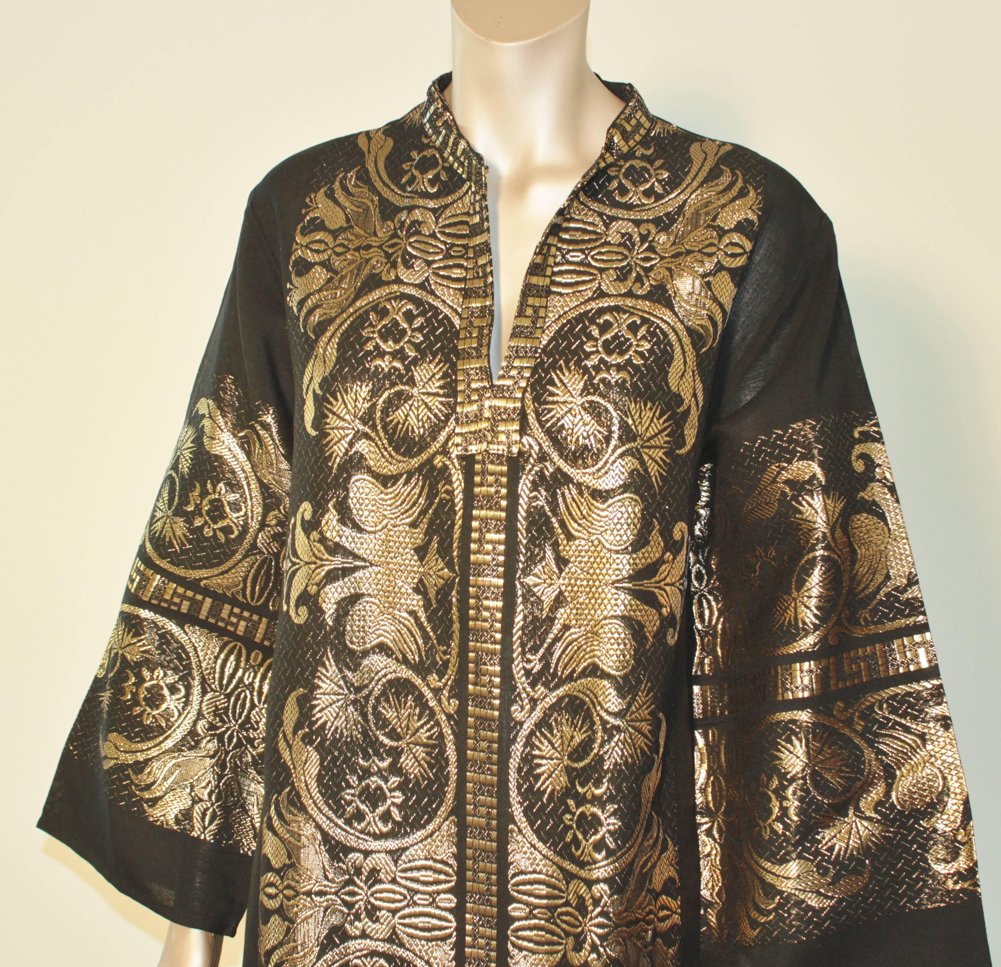 Vintage 1970s black cotton and gold lamé embroidered caftan maxi dress.
Long sleeves.
Absolutely beautiful maxi dress Kaftan made in Greece.
Rich golden metallic detailing all-over. 
Professionally cleaned and thoroughly checked before shipping.